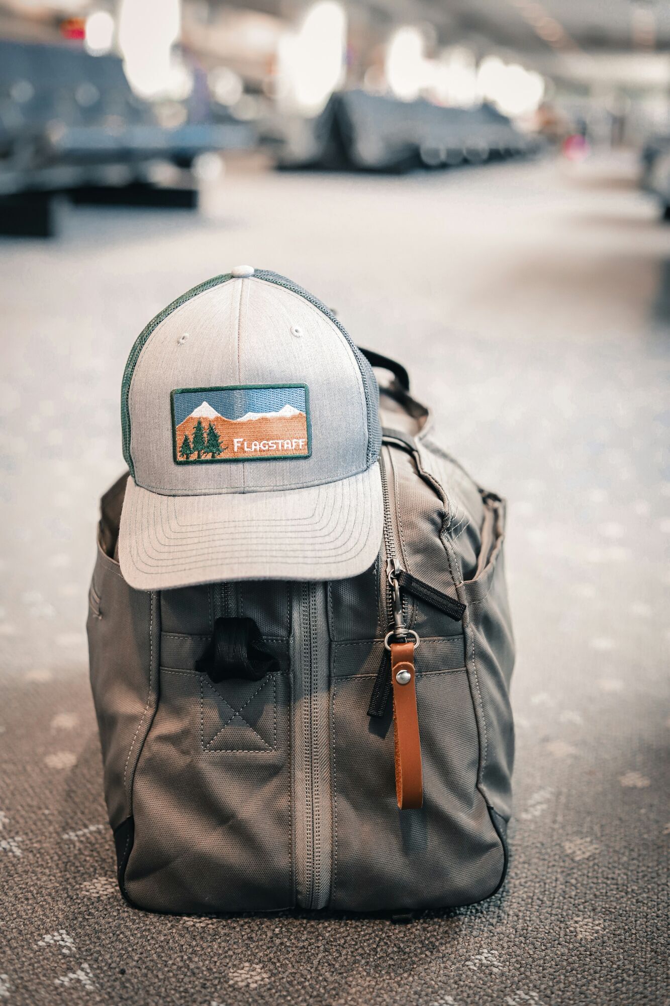 Small travel bag on an airport floor