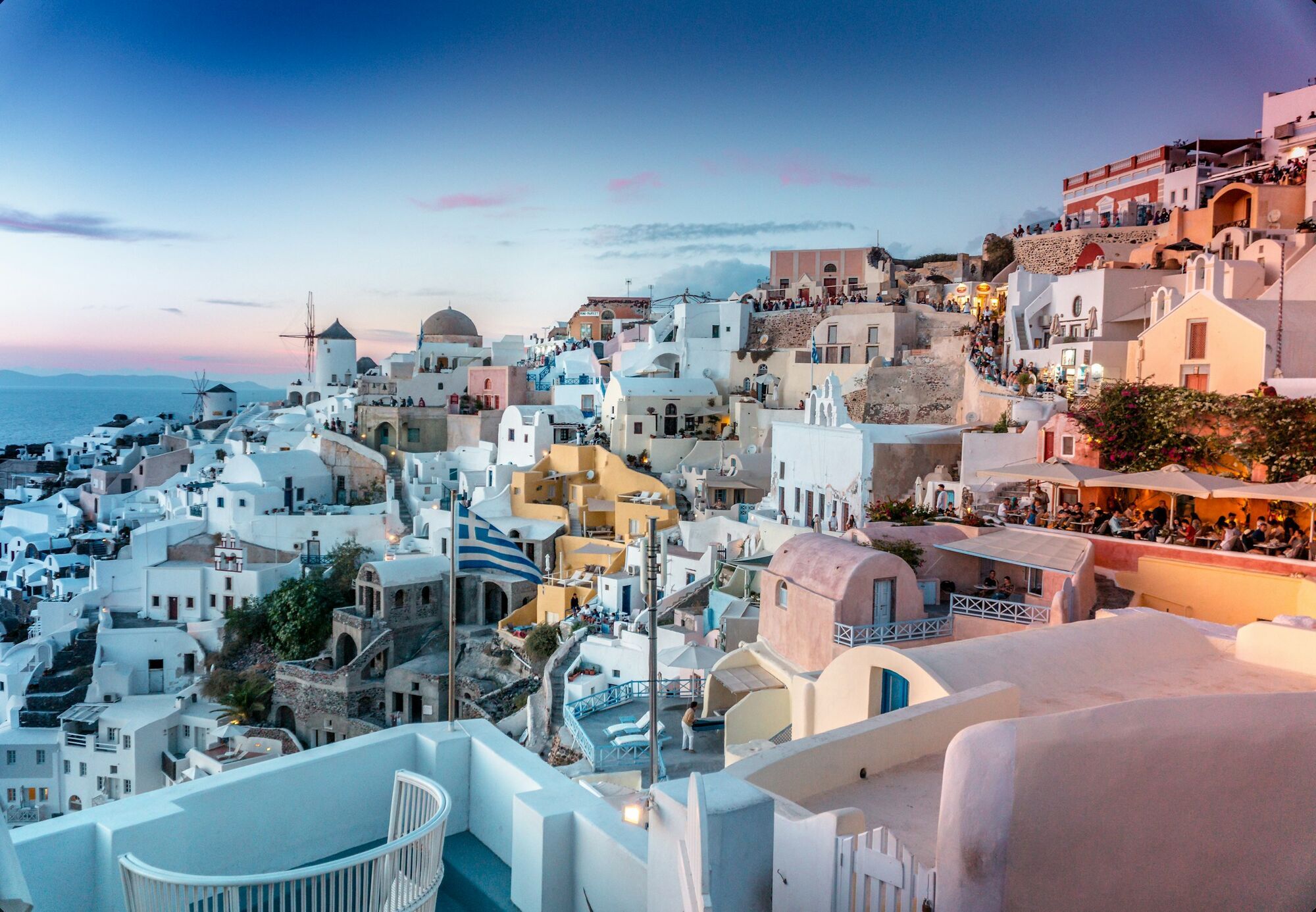 Santorini hillside with white buildings at sunset