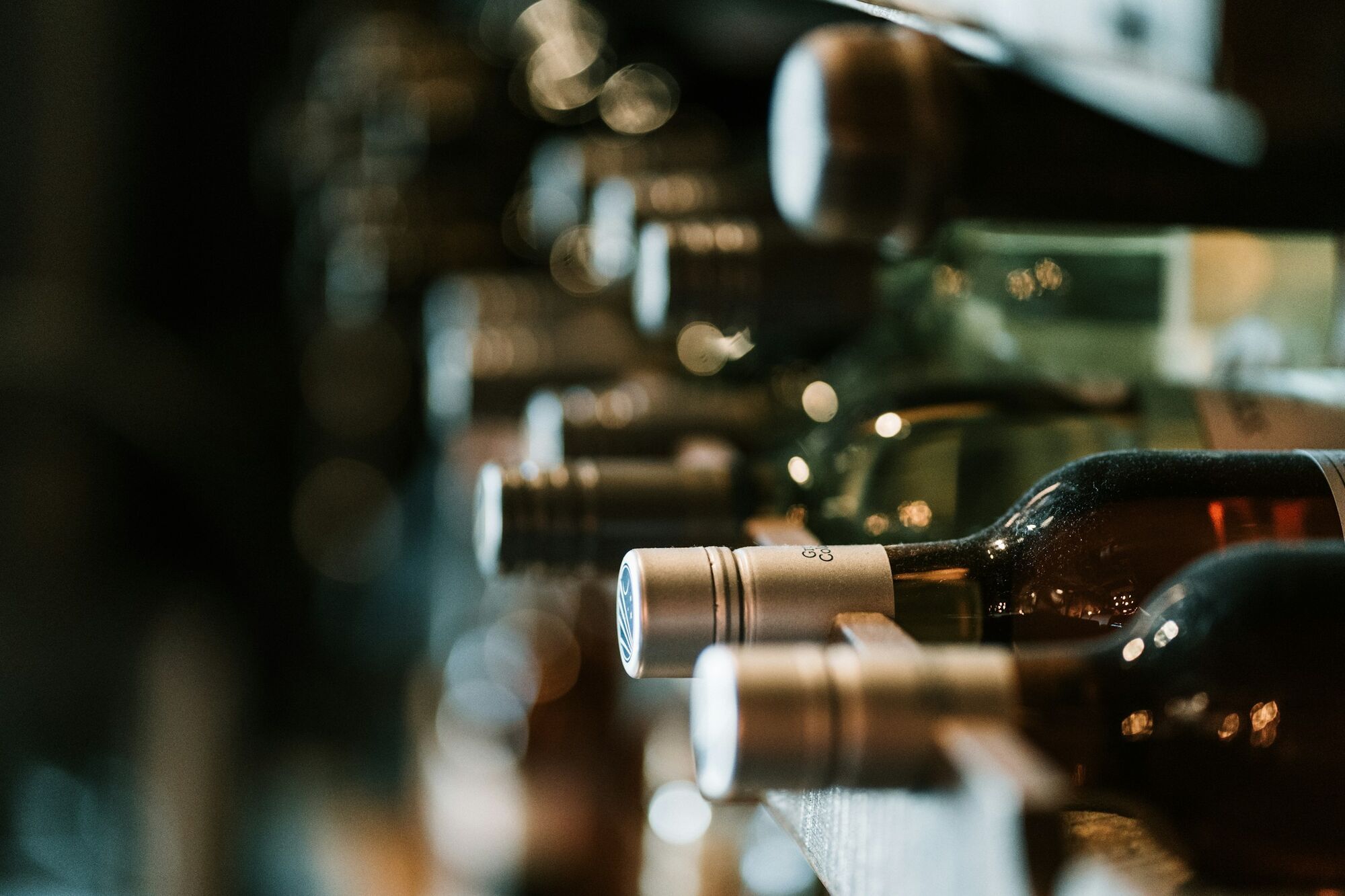 Wine bottles stored on cellar shelves