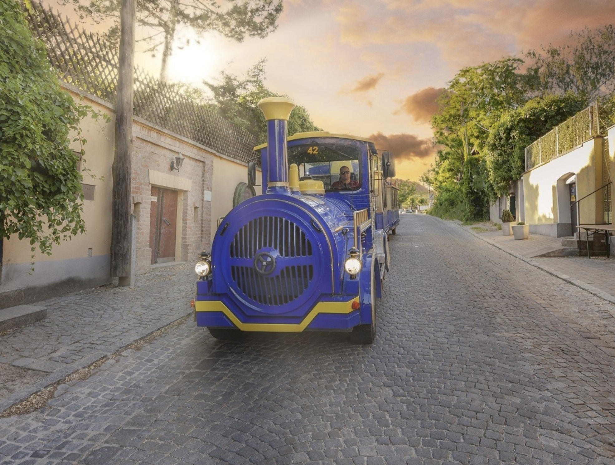 Blue Heurigen Express train on a cobbled Vienna street