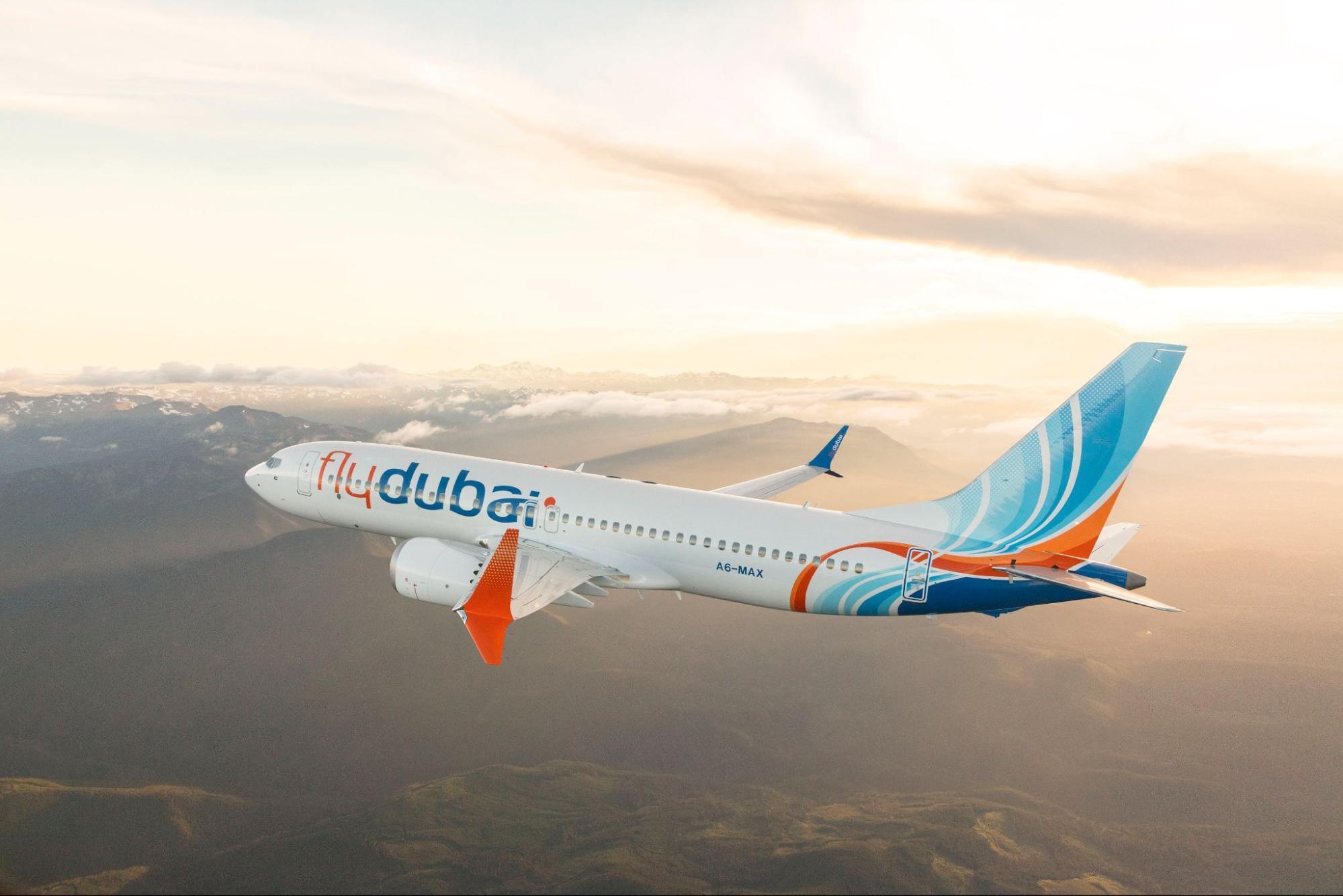 flydubai aircraft flying over a mountain landscape