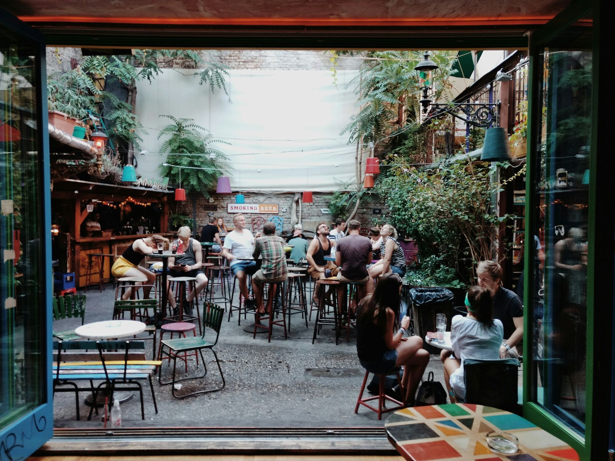 People sitting in an outdoor bar courtyard in Budapest