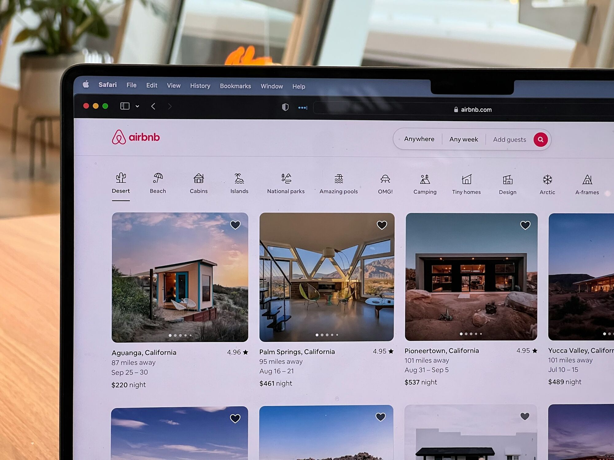 Airbnb website open on a laptop showing rental listings