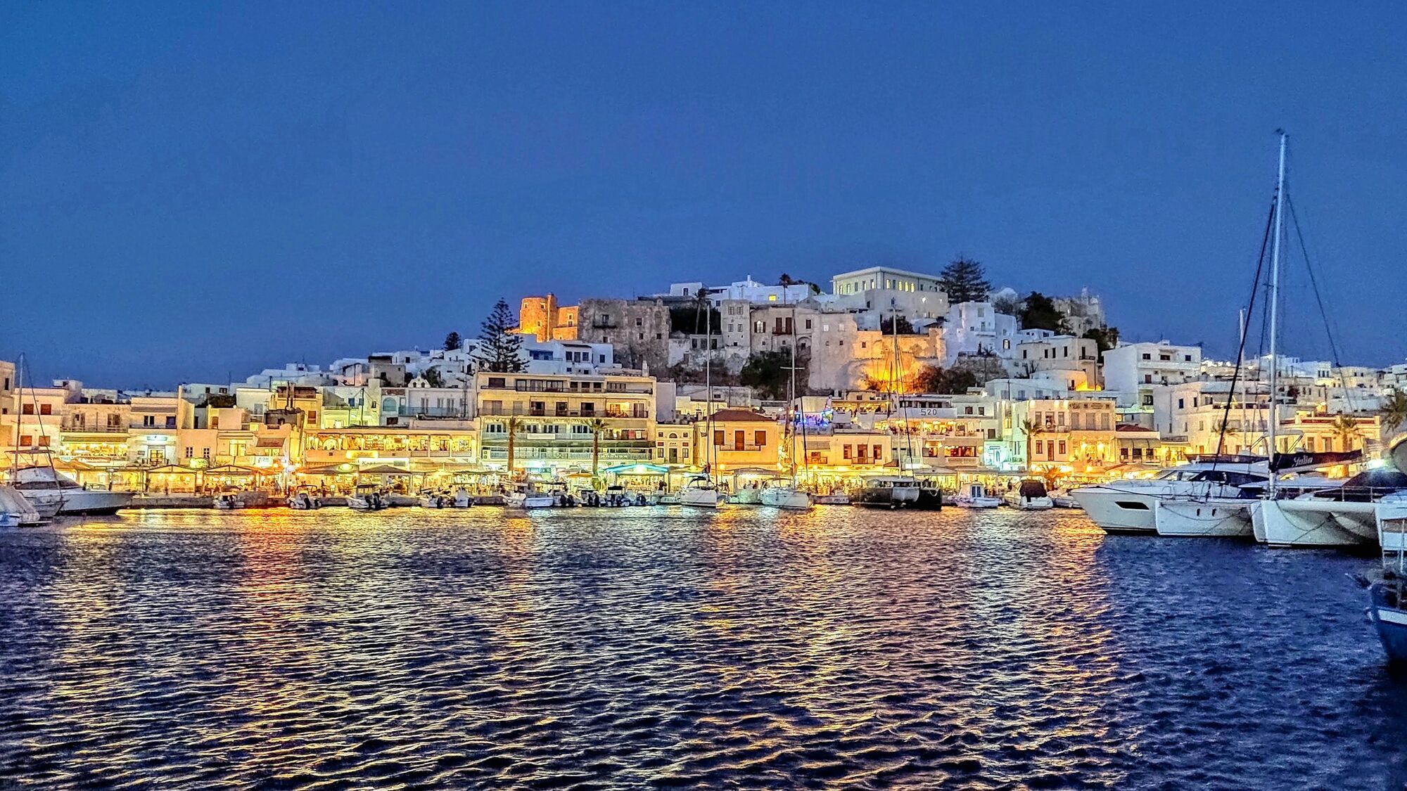Naxos harbour lit up at night