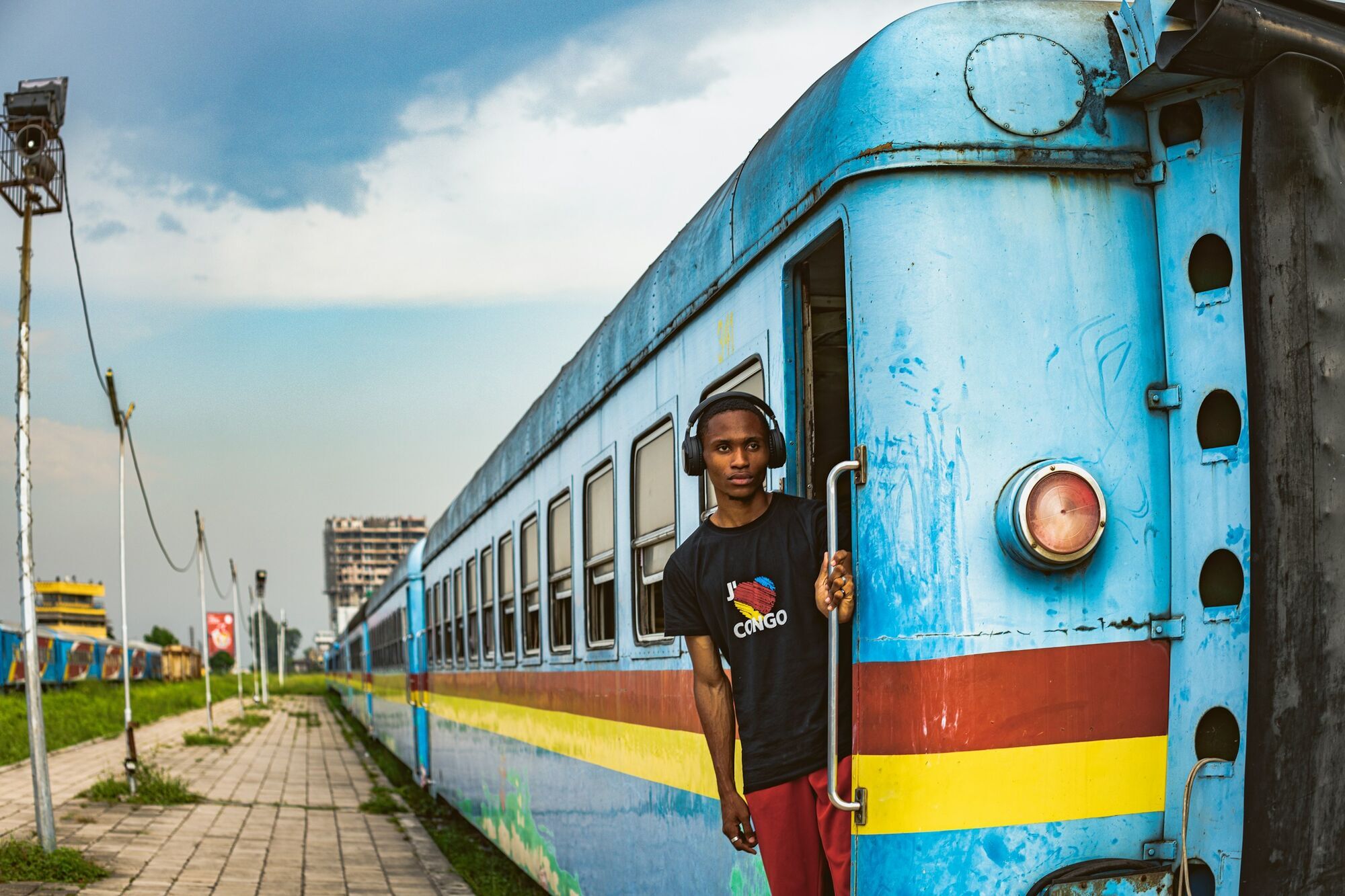 Passenger standing at the door of a train in Congo