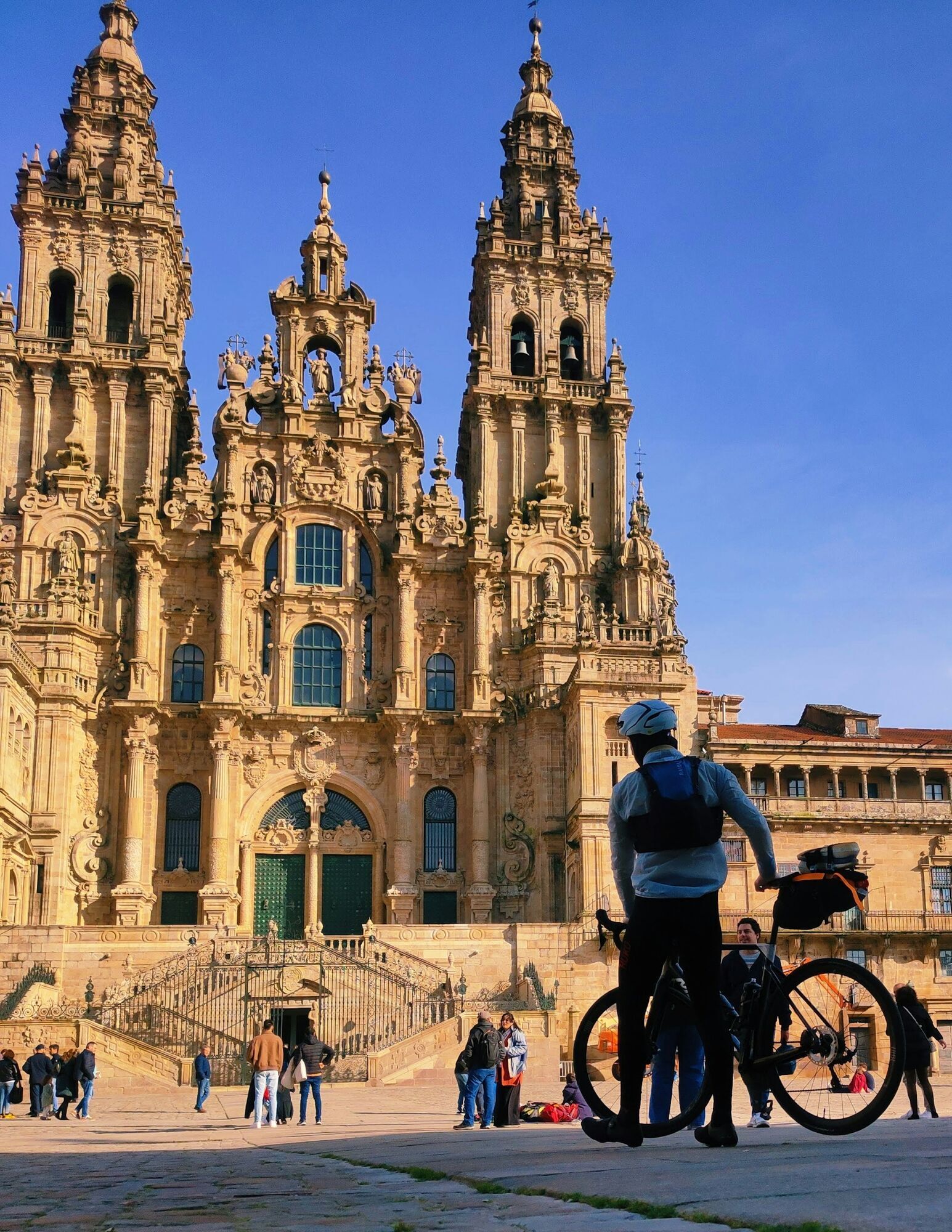 Cyclist outside Santiago de Compostela Cathedral