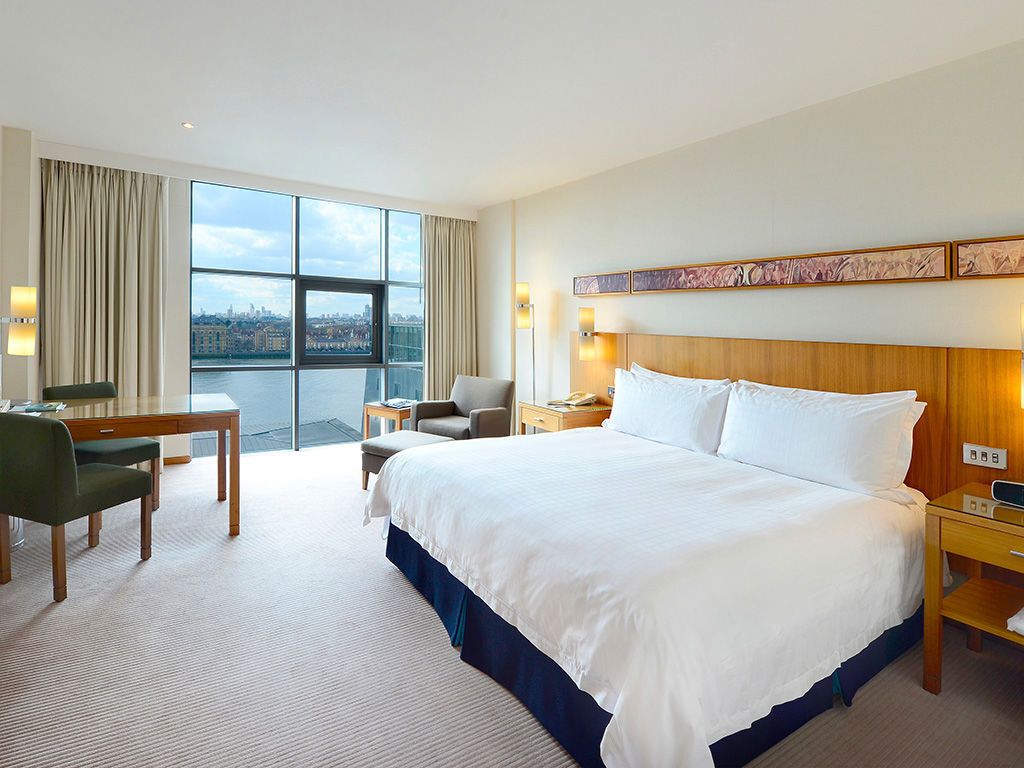 Bright hotel bedroom with large windows