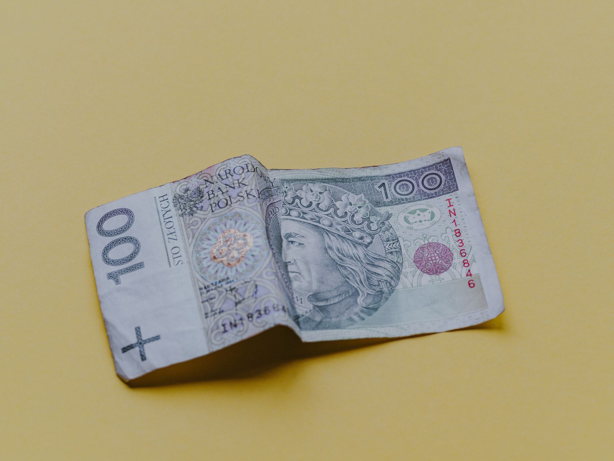 Polish 100 zloty banknote on yellow background