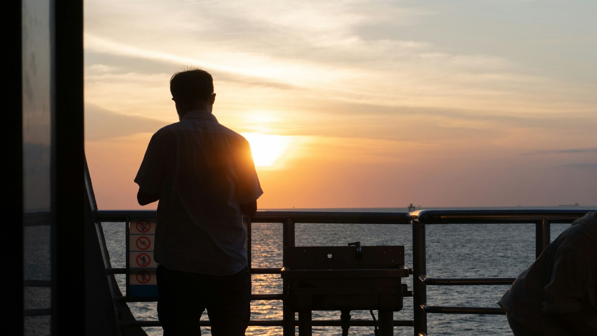 Passenger looking out to sea from a ferry