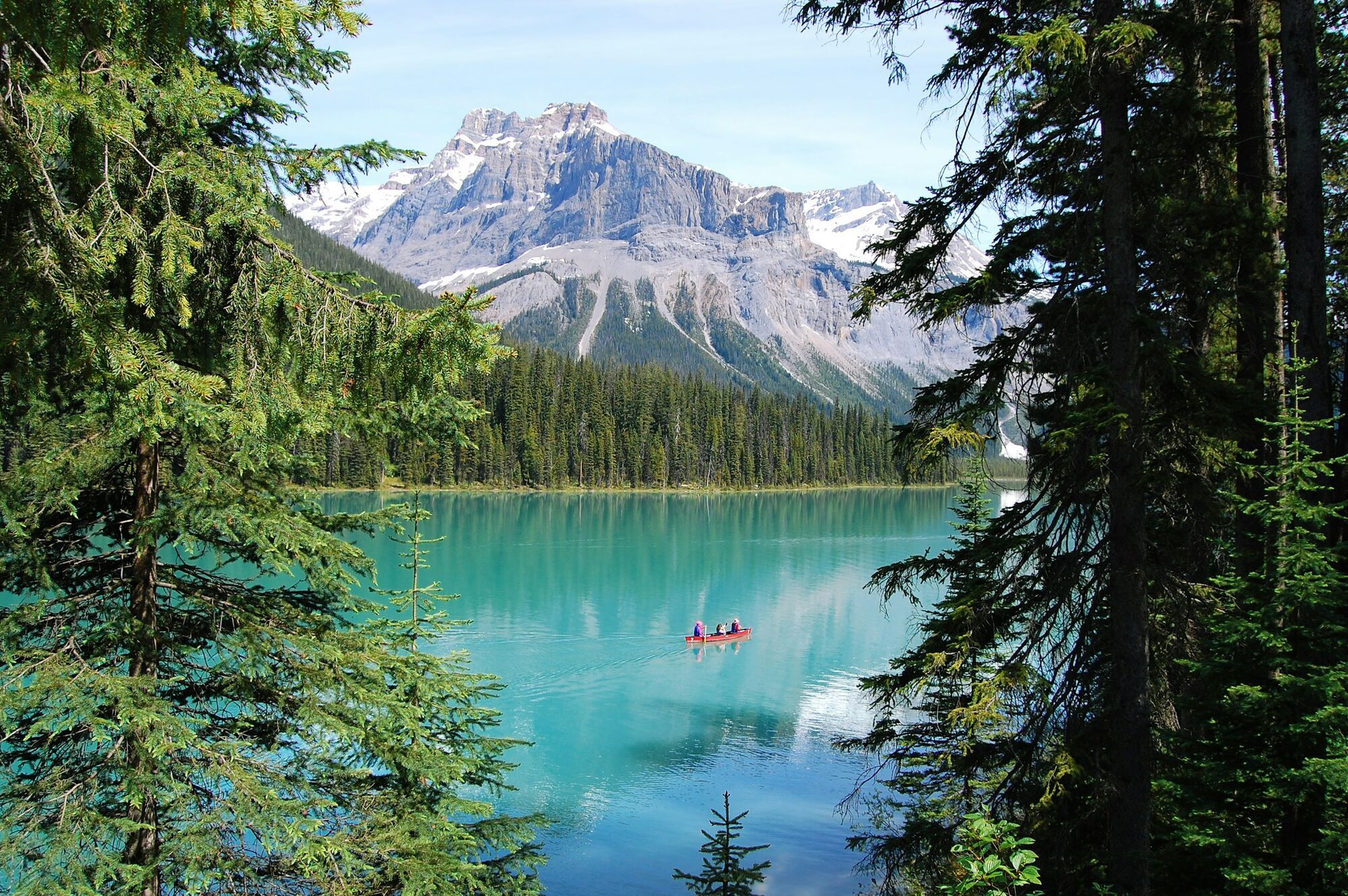 Mountain lake in Canada with canoe and forest