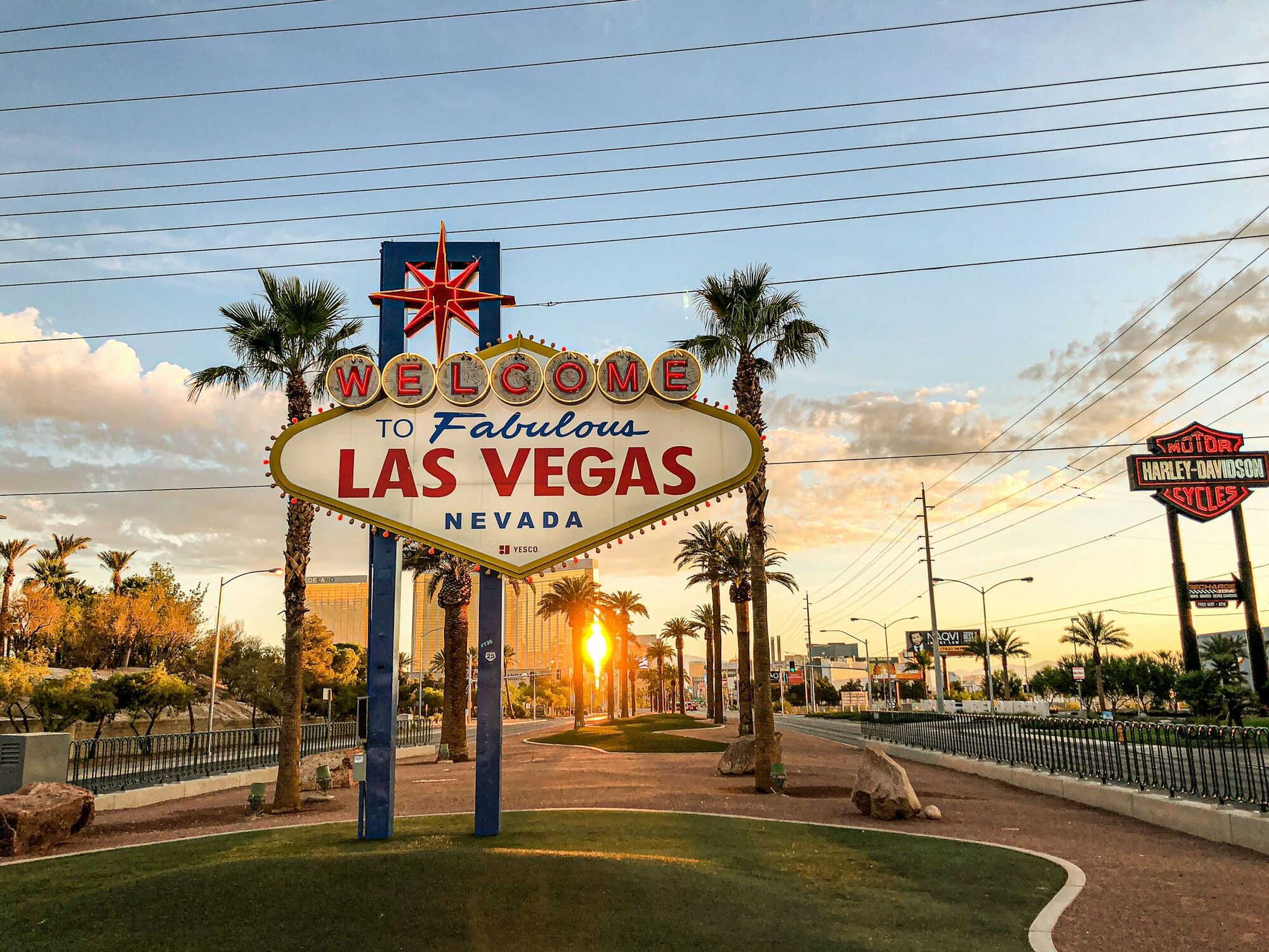 Welcome to Las Vegas sign at sunset with palm trees