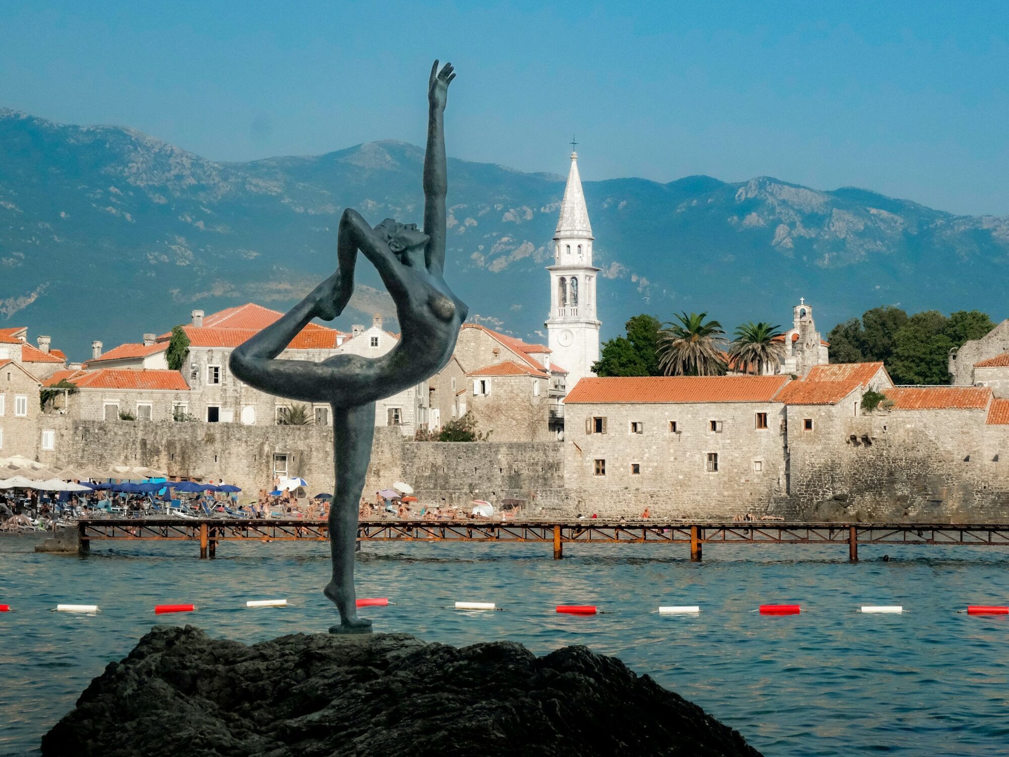 Budva Old Town and waterfront with a dancer statue by the Adriatic Sea