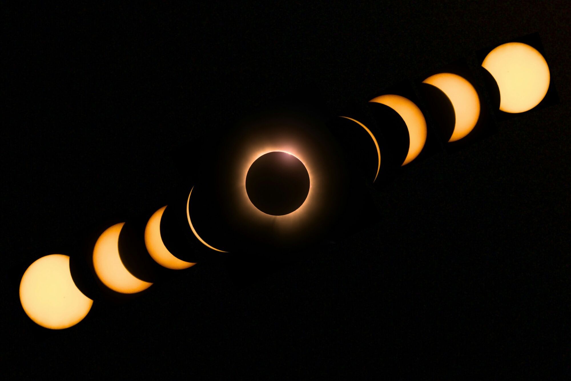 Composite image showing the stages of a solar eclipse against a dark sky