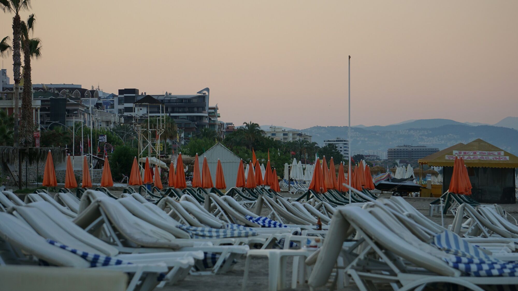 Rows of empty sun loungers on a beach