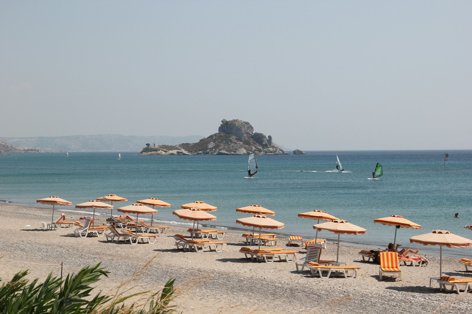 Sun loungers and parasols on a beach in Kos