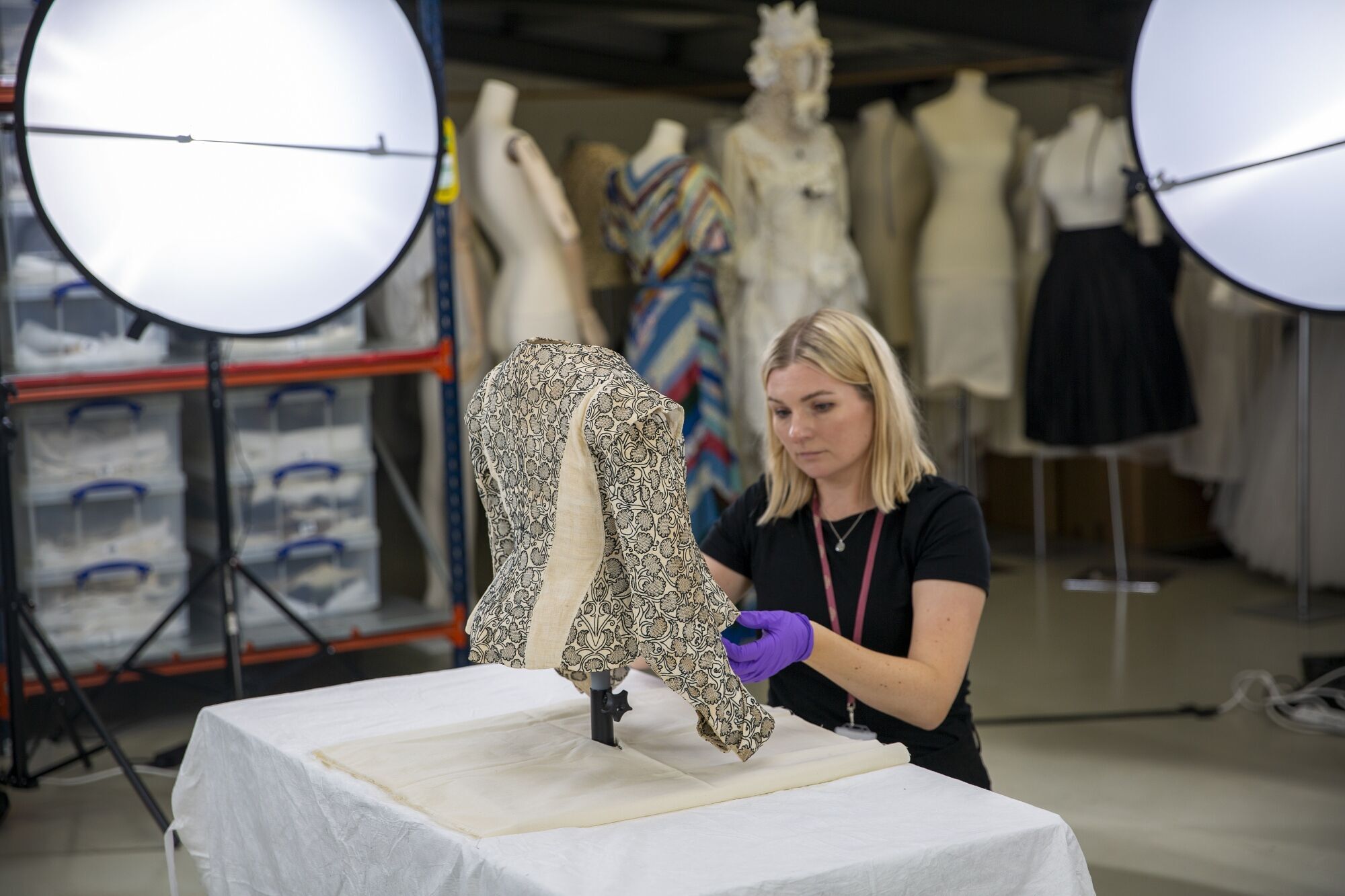 Fashion Museum Bath staff member working with a historic garment