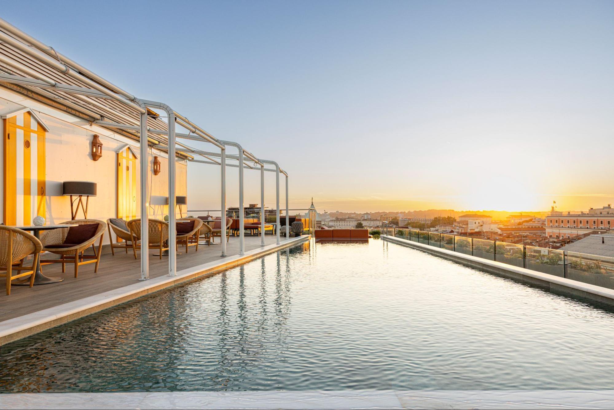 Rooftop pool at Anantara Palazzo Naiadi Rome Hotel at sunset