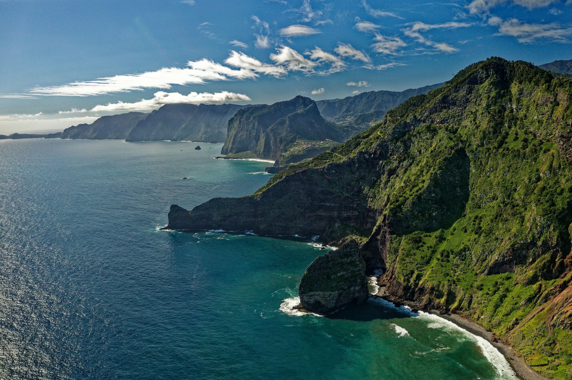 Madeira coastline with green cliffs and Atlantic Ocean
