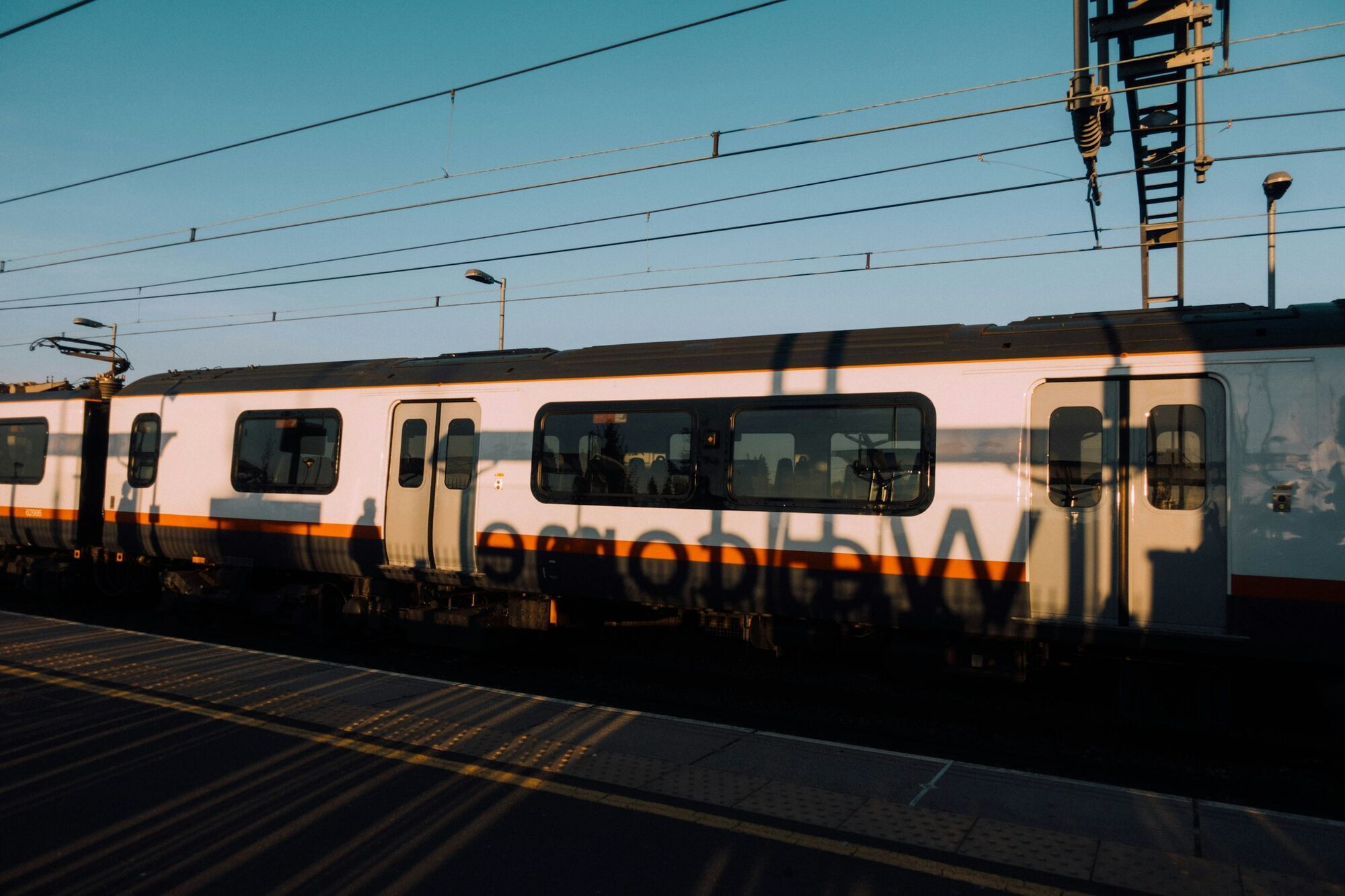 Train standing at a platform in evening light