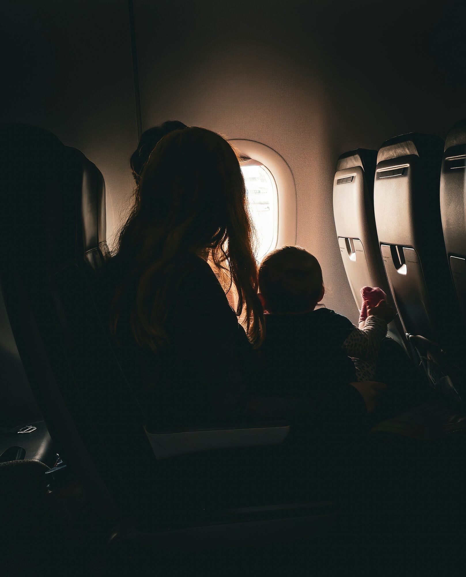 Adult travelling with a child on a plane