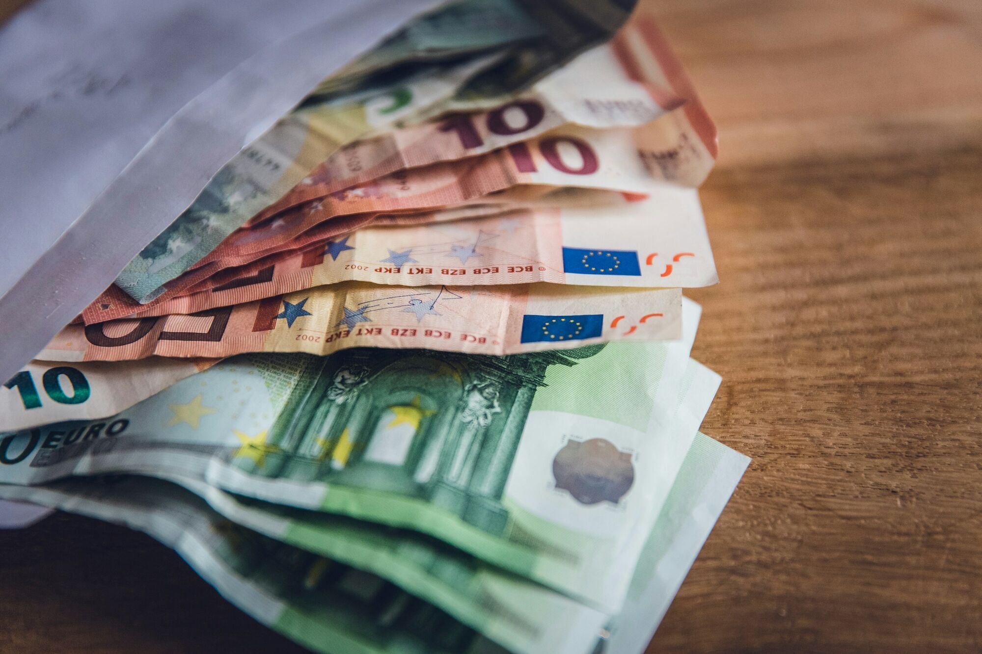 Euro banknotes partly inside an envelope