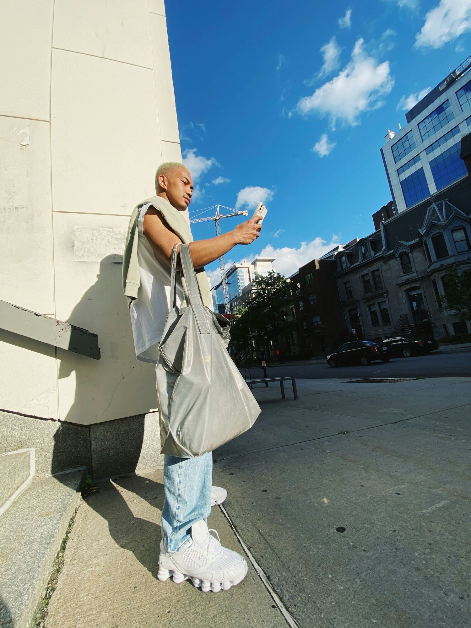 Traveller using a phone on a city street