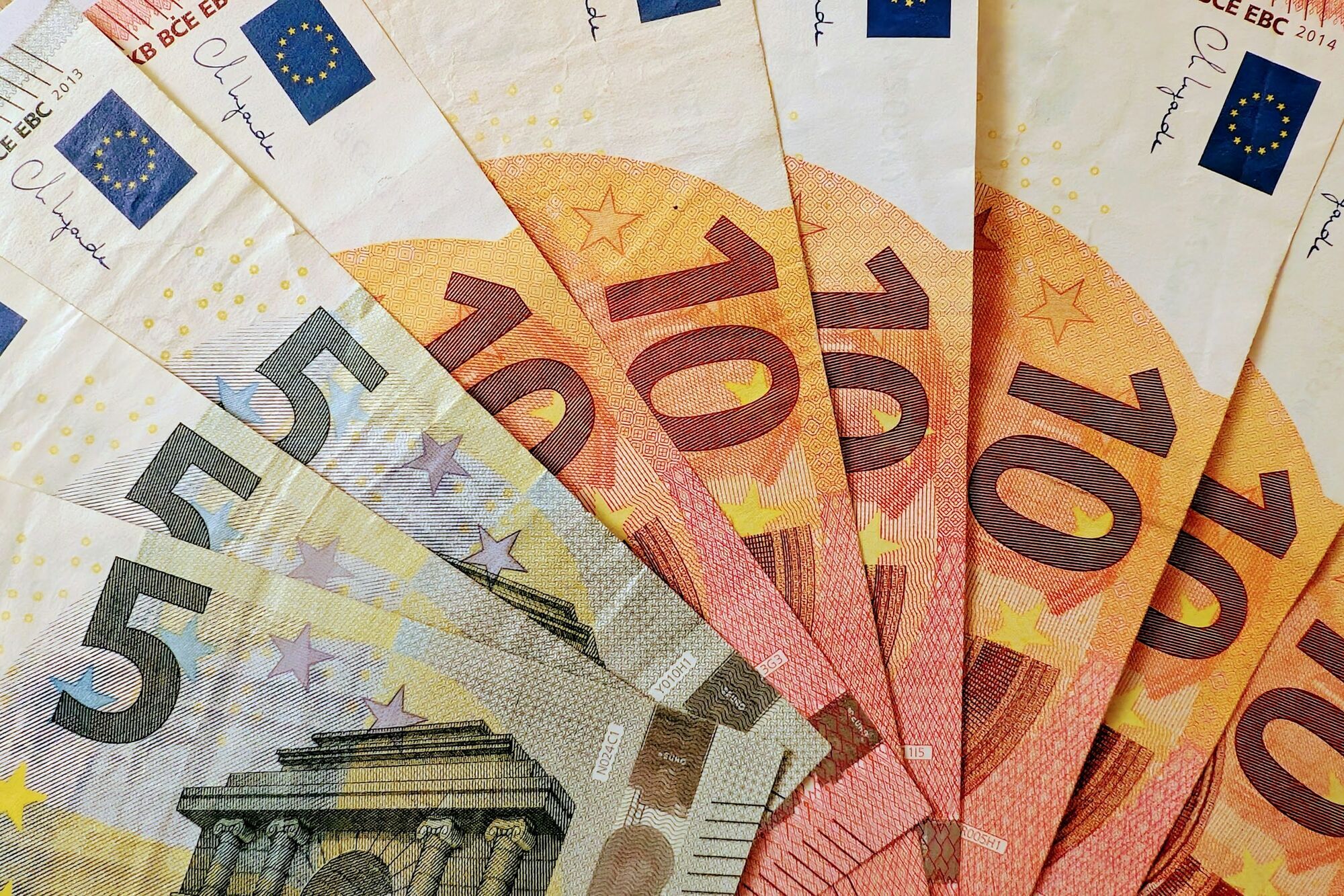 Euro banknotes spread across a table