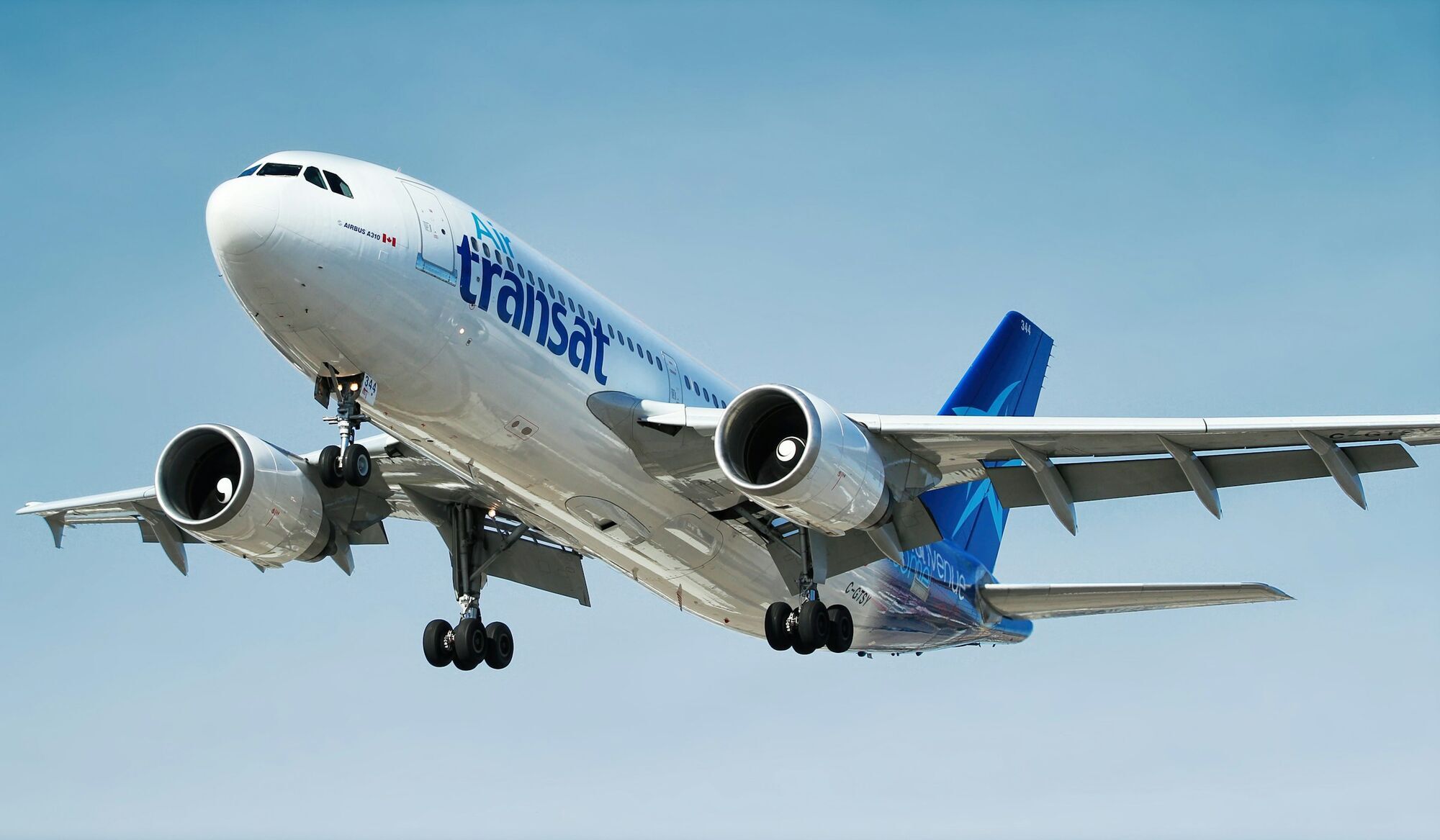 Air Transat aircraft flying against a clear blue sky