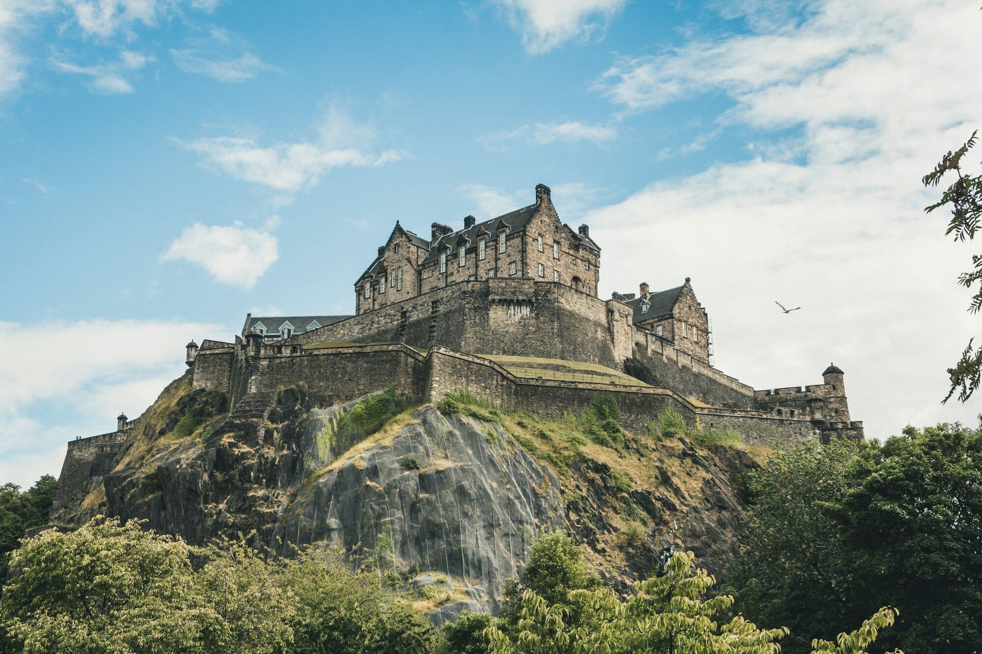 Edinburgh Castle on a rocky hill under a cloudy sky