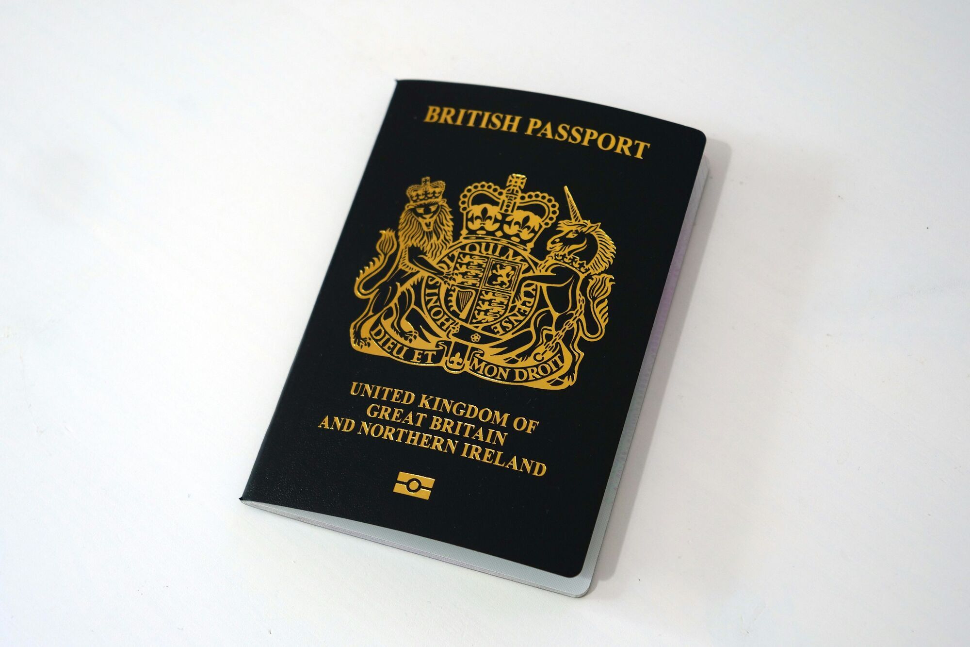 British passport lying on a plain white surface