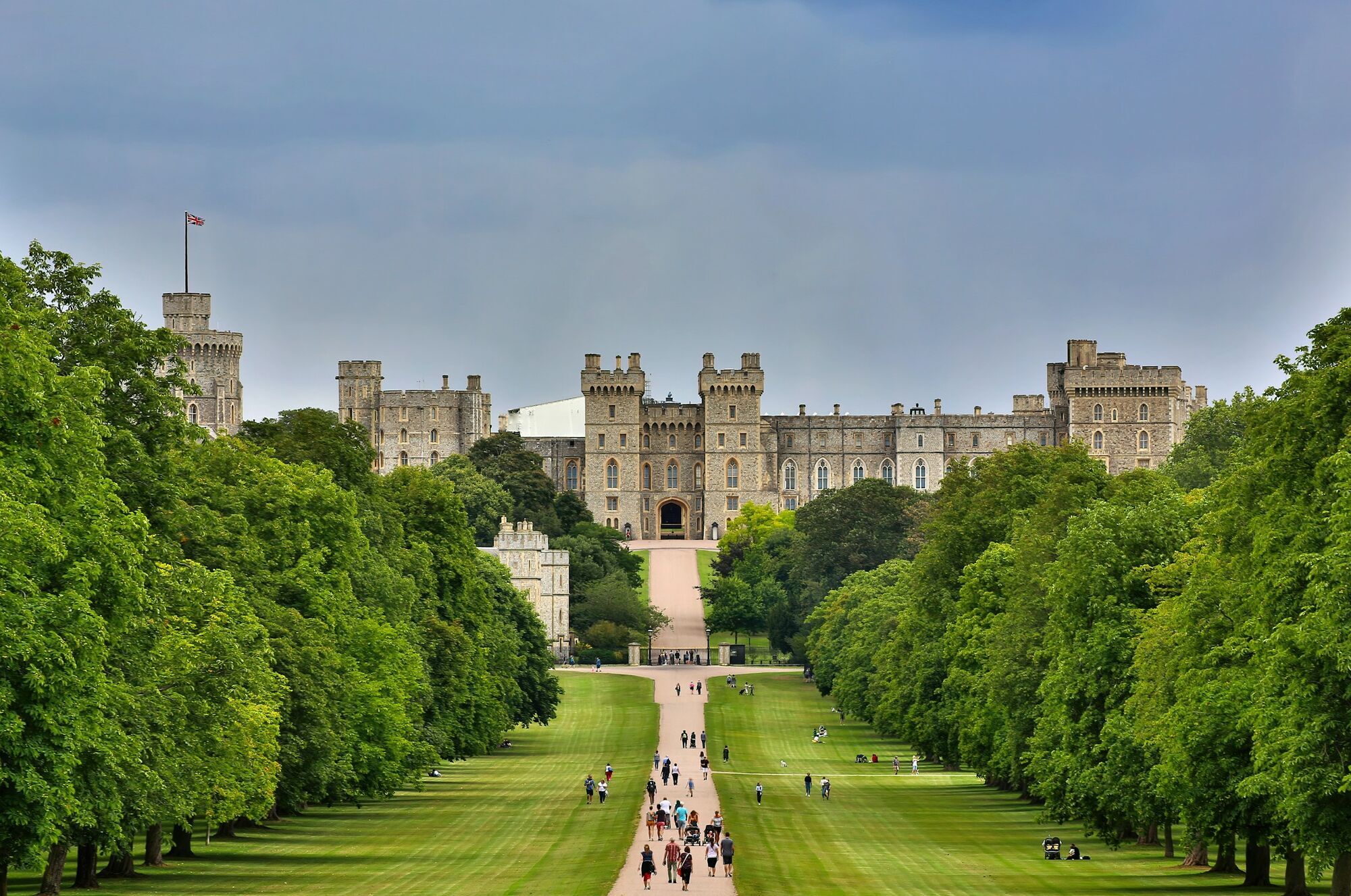Windsor Castle seen from the Long Walk with visitors nearby