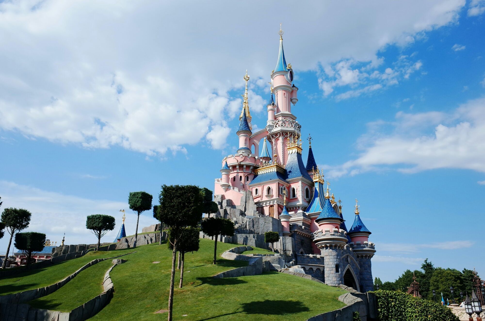 Sleeping Beauty Castle at Disneyland Paris under a blue sky