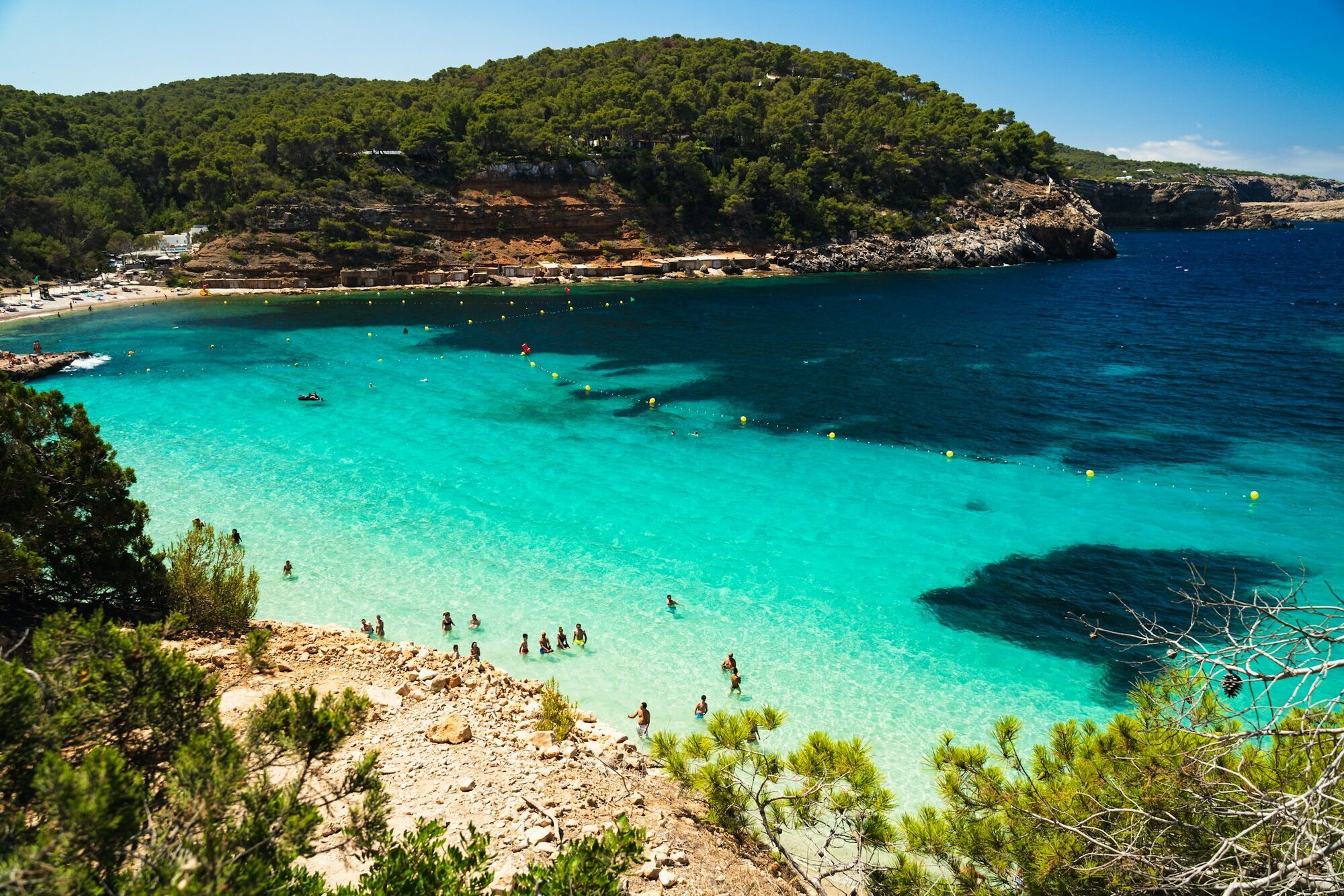 Turquoise Mediterranean bay with swimmers
