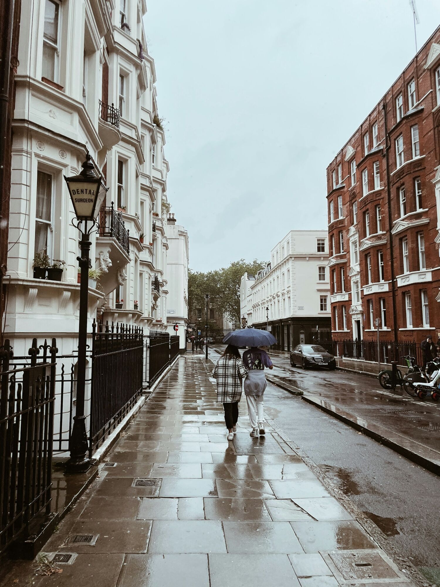 People walking with umbrellas on a rainy London street