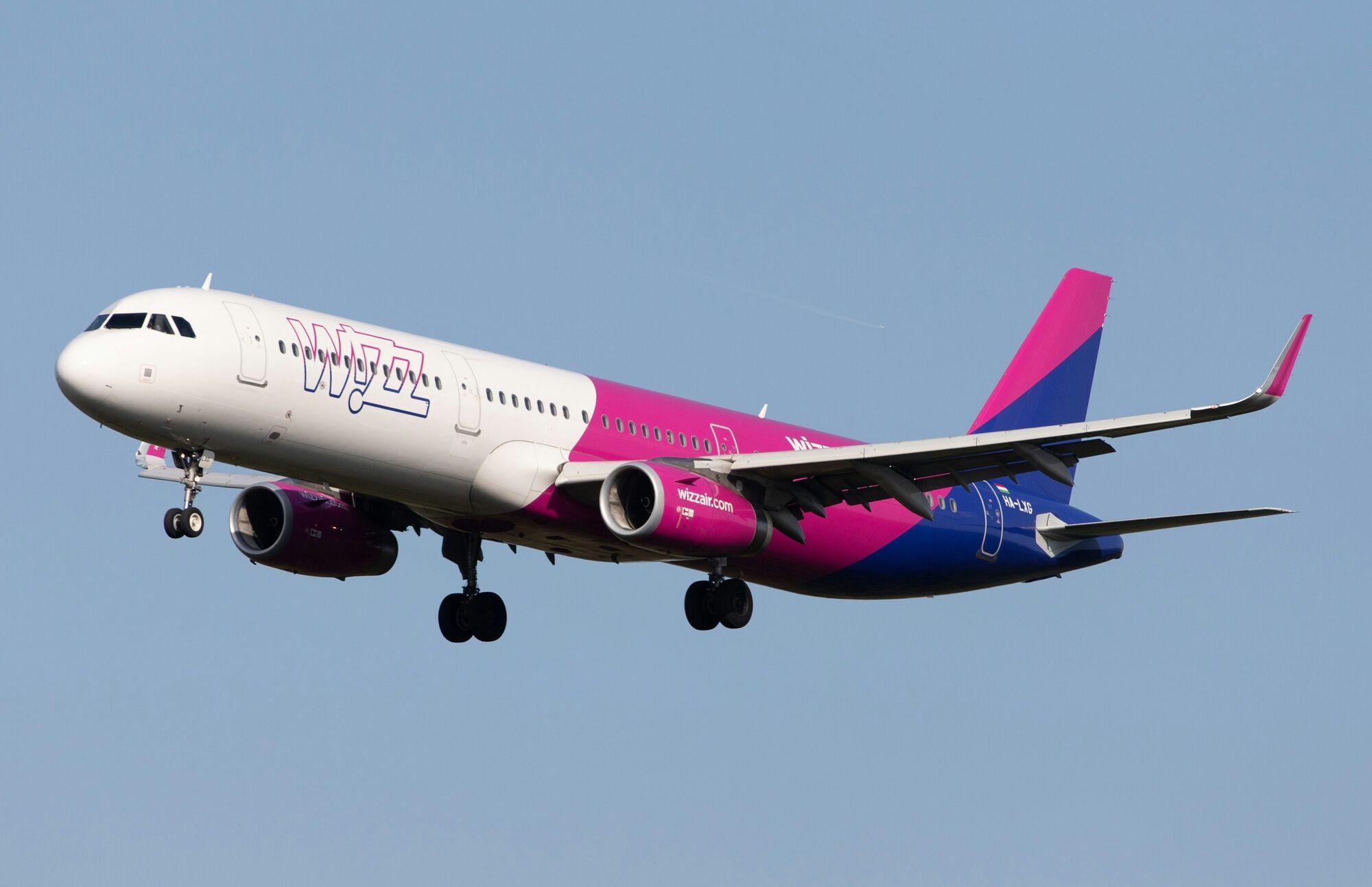 Wizz Air aircraft landing against a clear sky