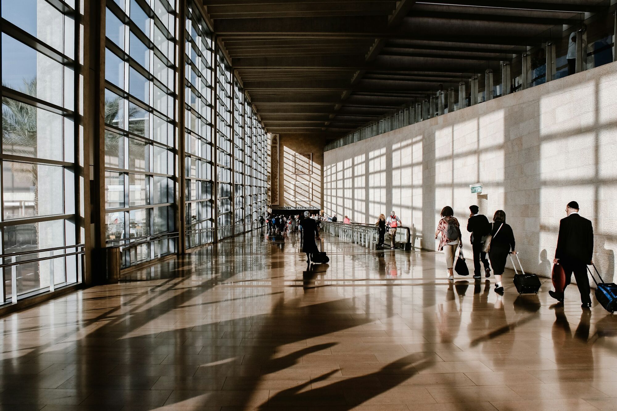 Passengers walking through an airport departure terminal