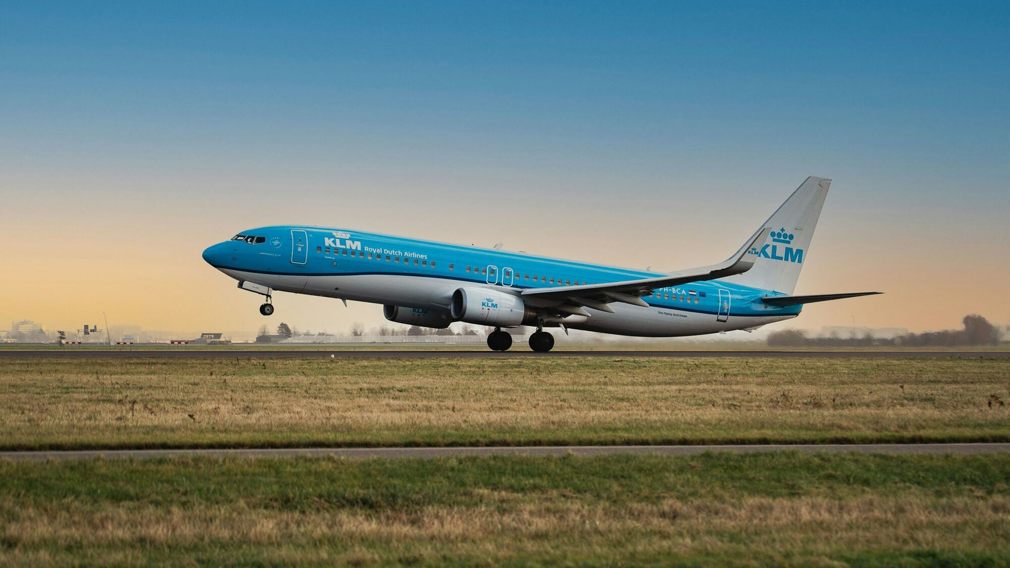 KLM aircraft taking off from an airport runway