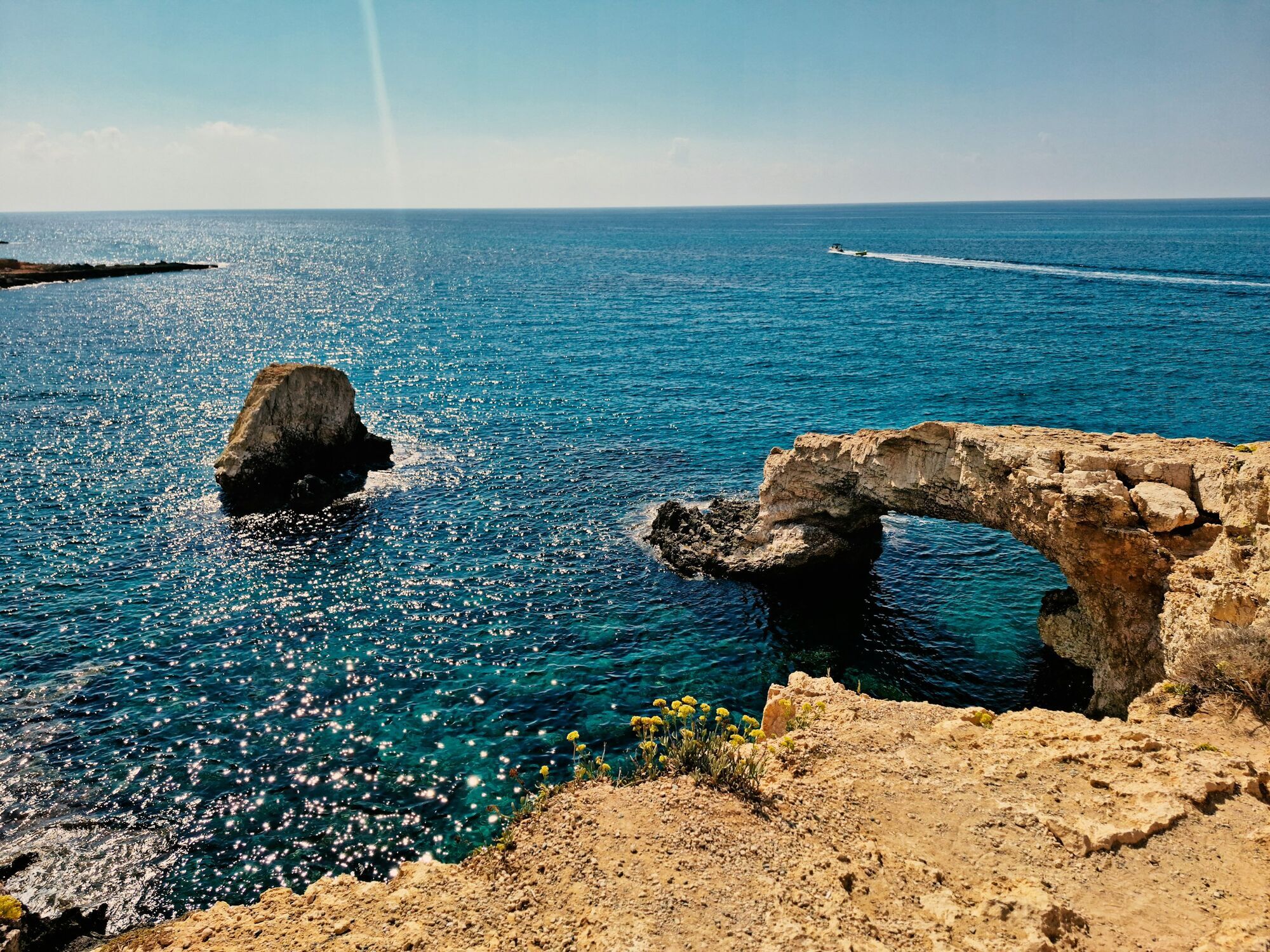 Rocky sea arch and deep blue water on the Cyprus coast