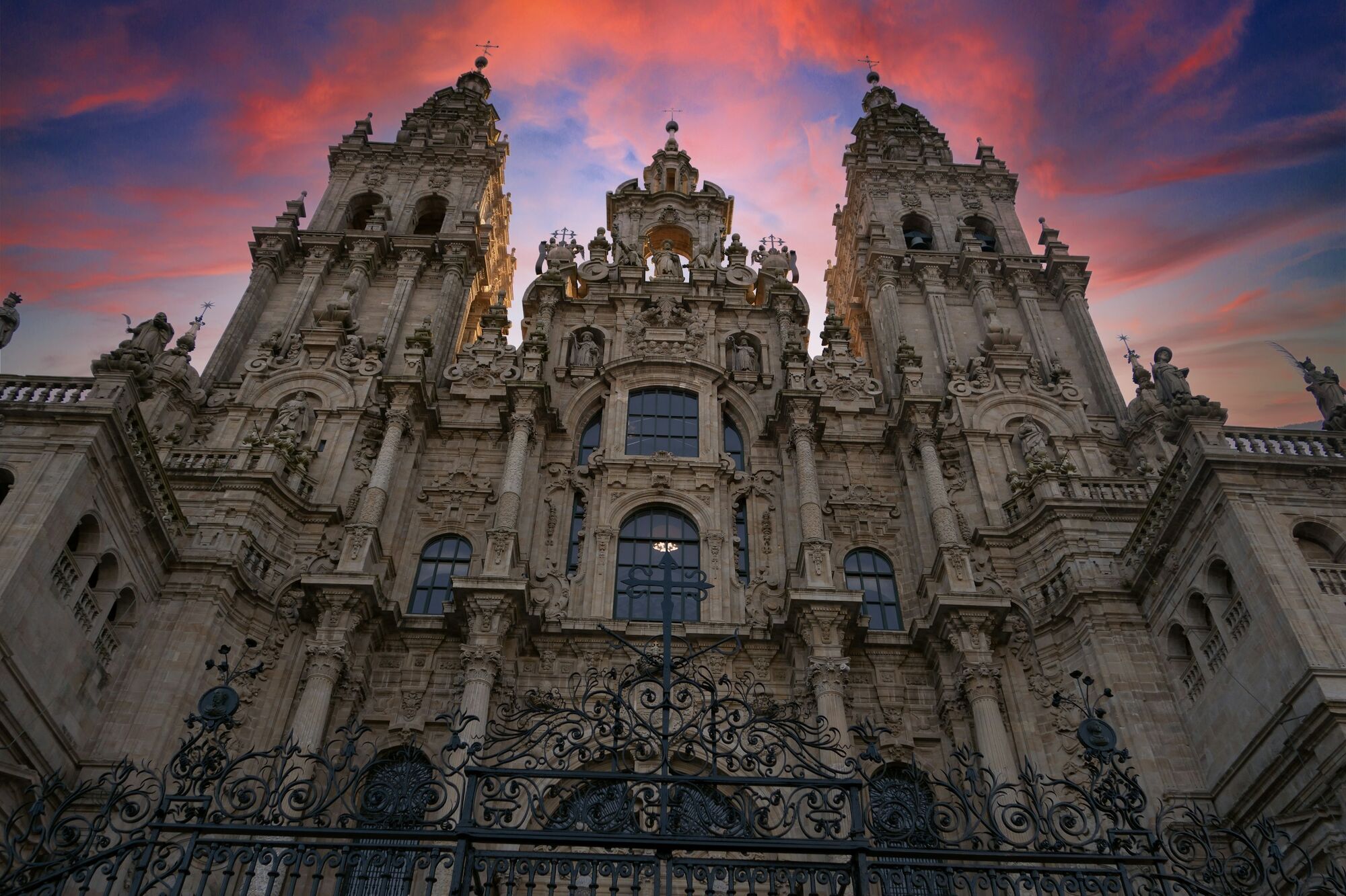 Santiago de Compostela Cathedral at sunset behind ornate gates