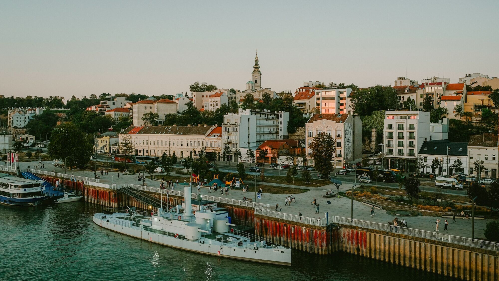 Belgrade riverside with buildings and boats at sunset