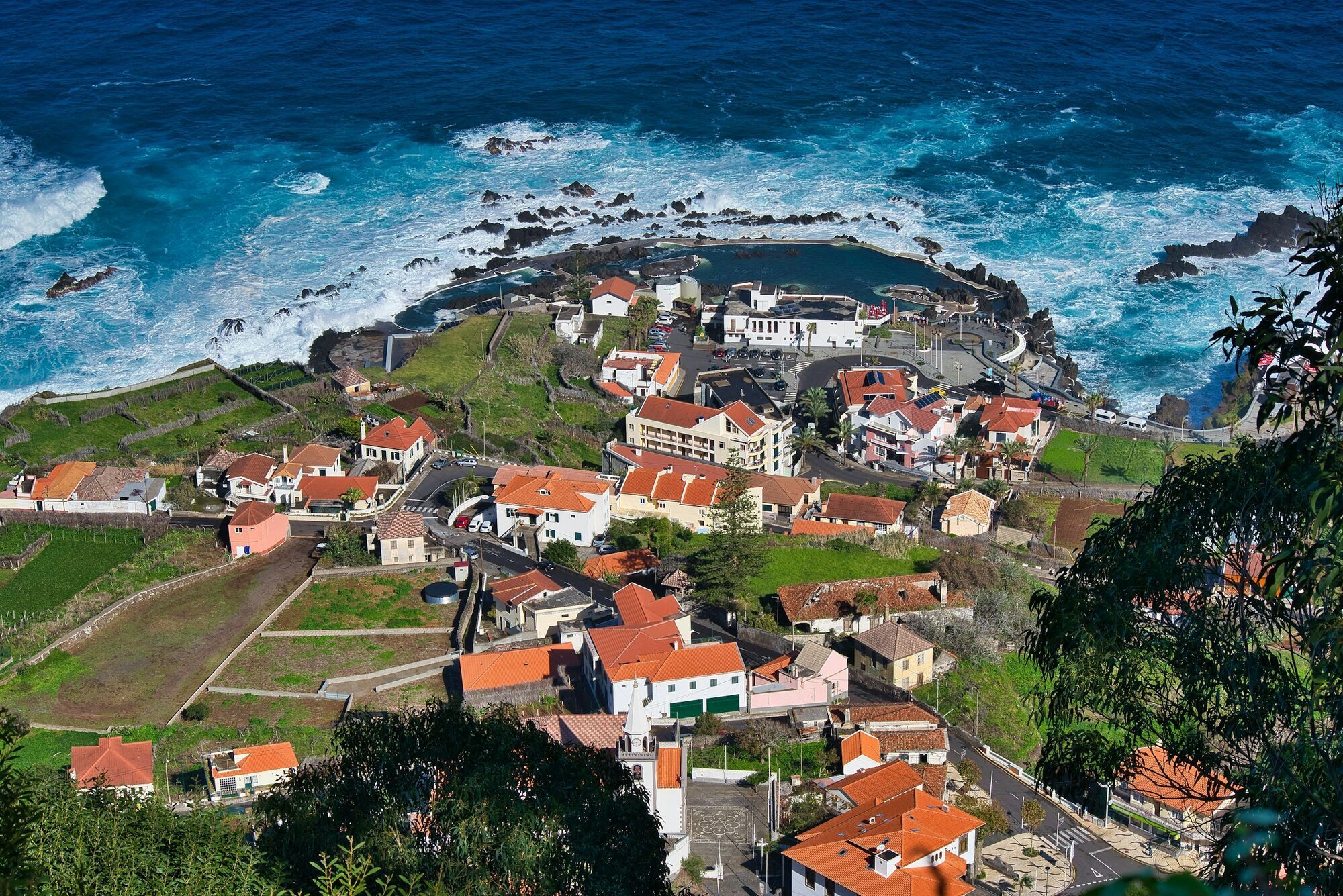 Coastal village with ocean pools and waves
