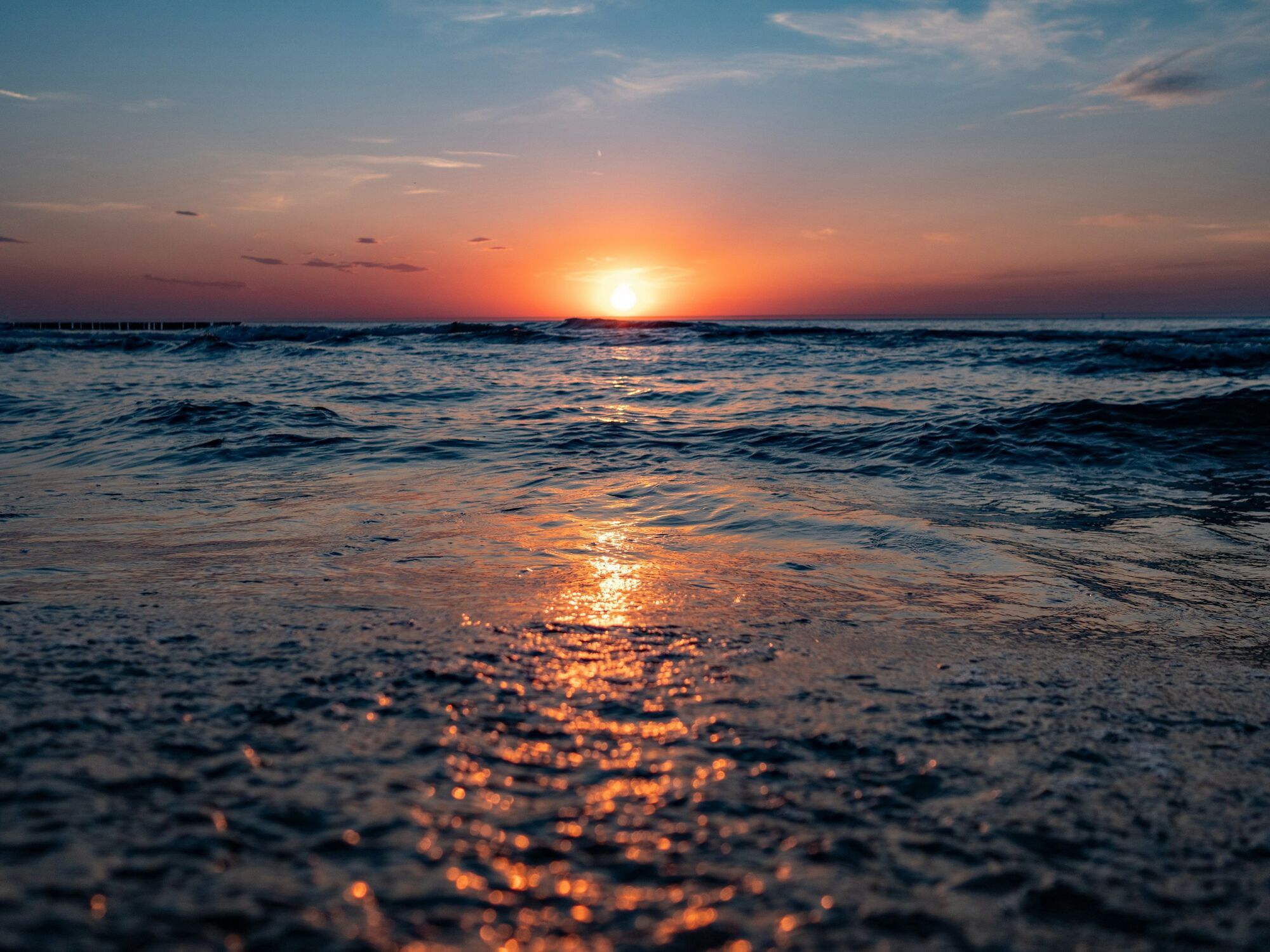 Sunset over waves on the Baltic Sea coast