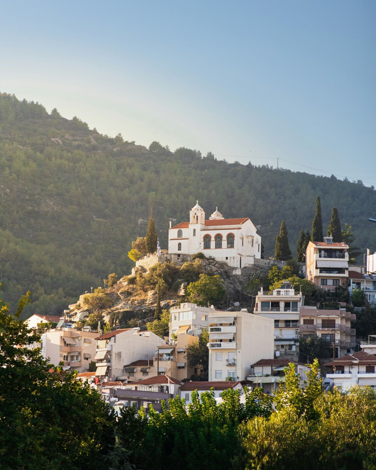 White church above Kavala hillside homes