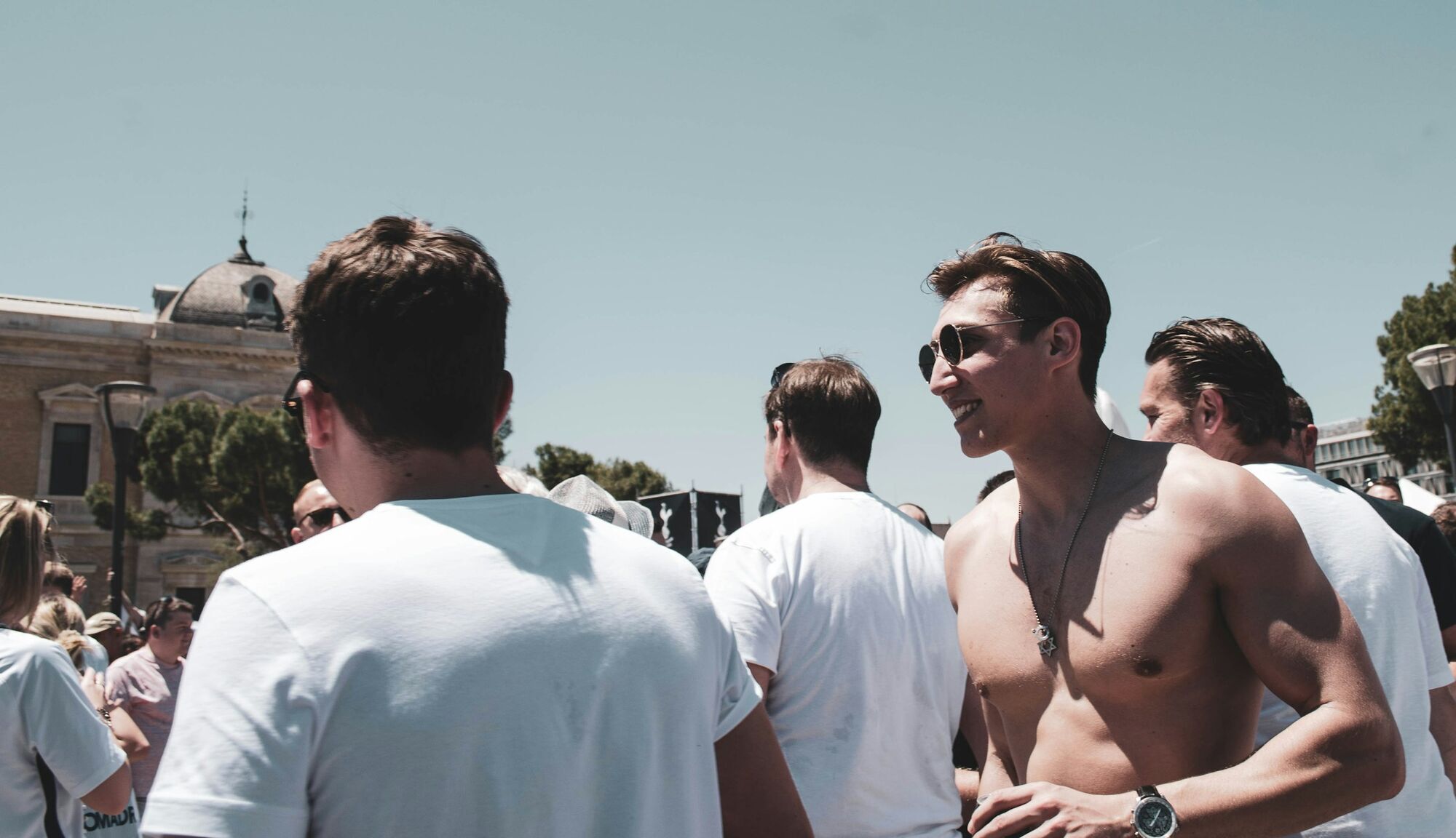 Shirtless tourist in a crowded Italian street
