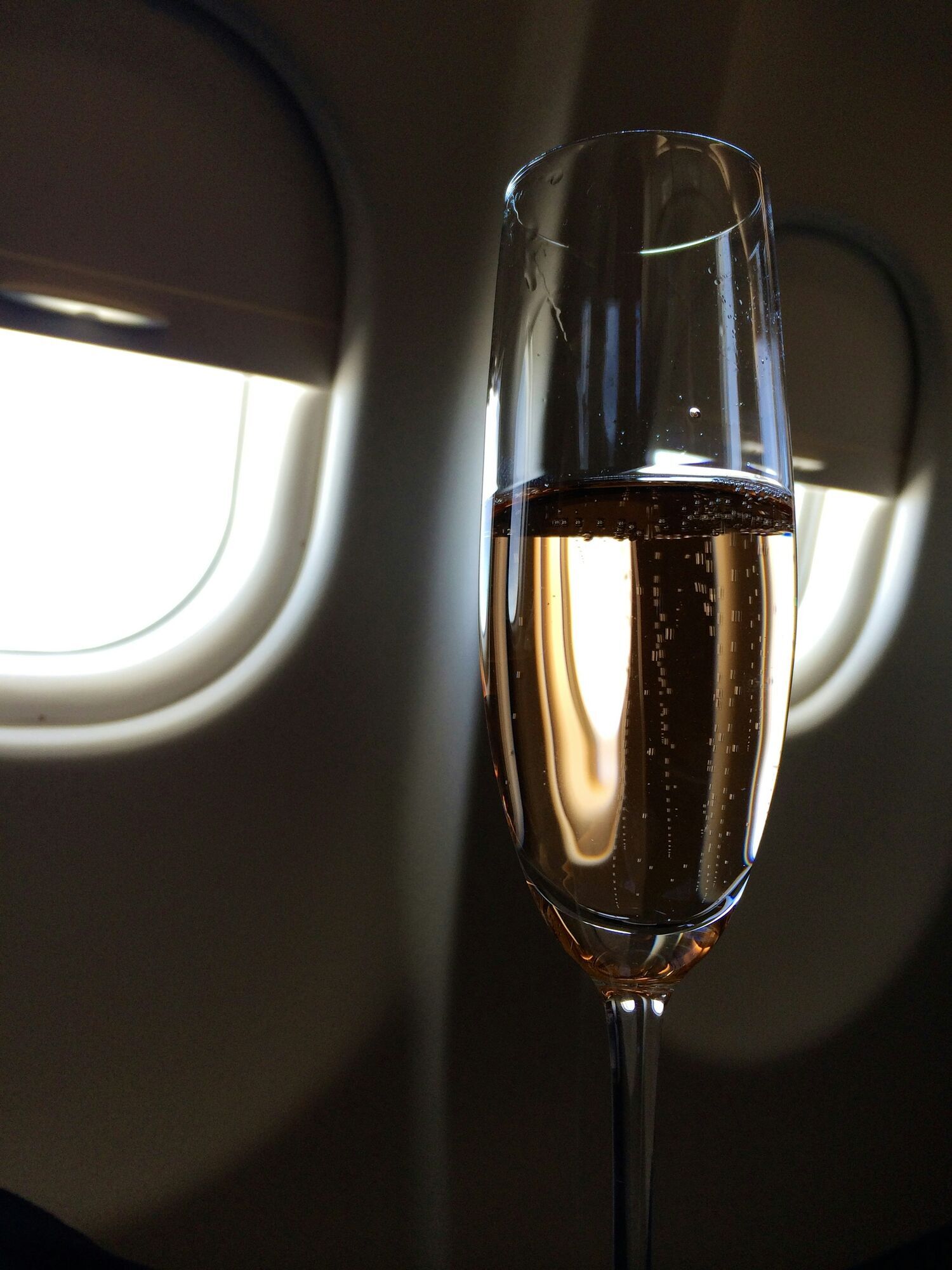 Glass of sparkling wine on an aircraft