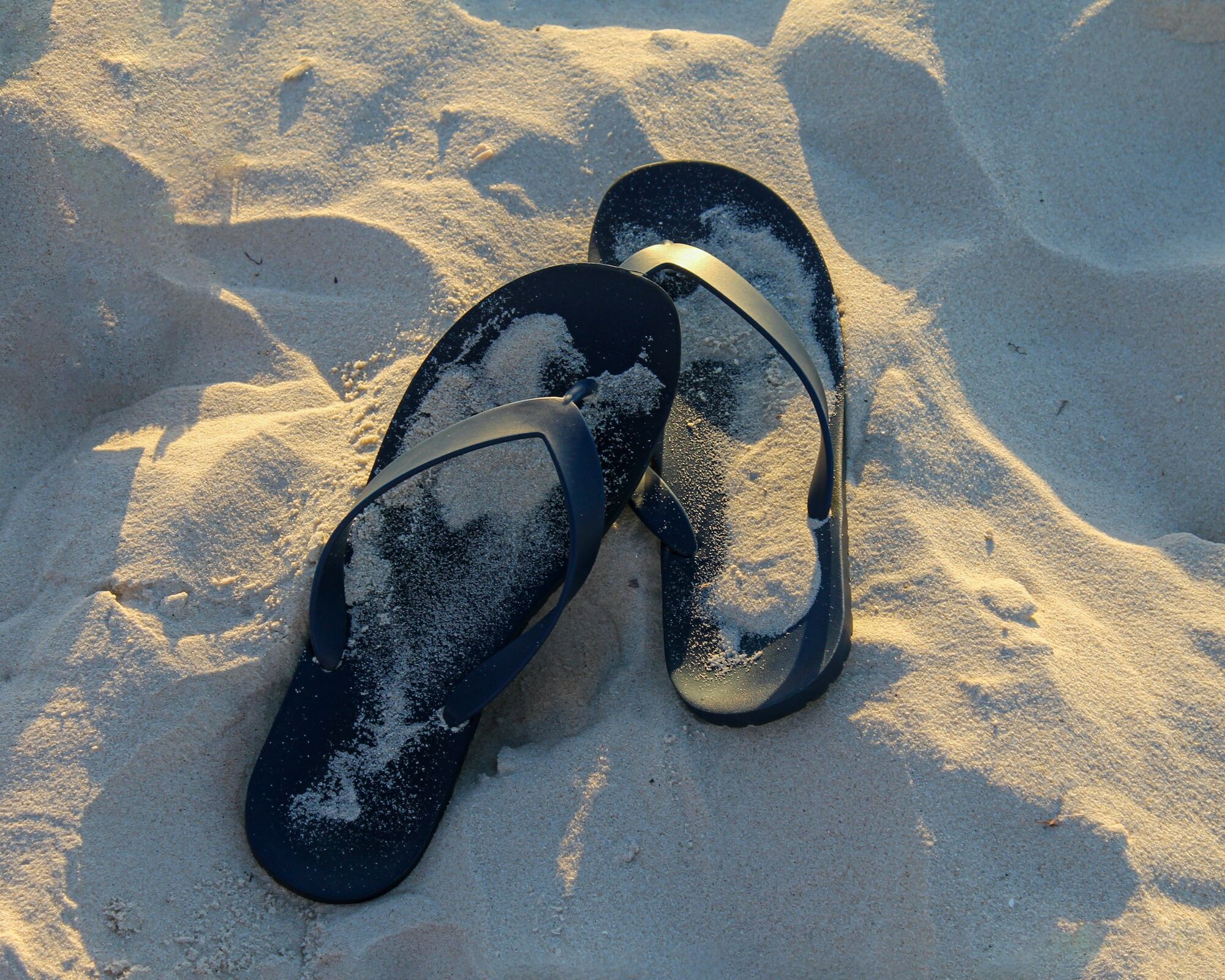 Flip-flops left on a sandy beach