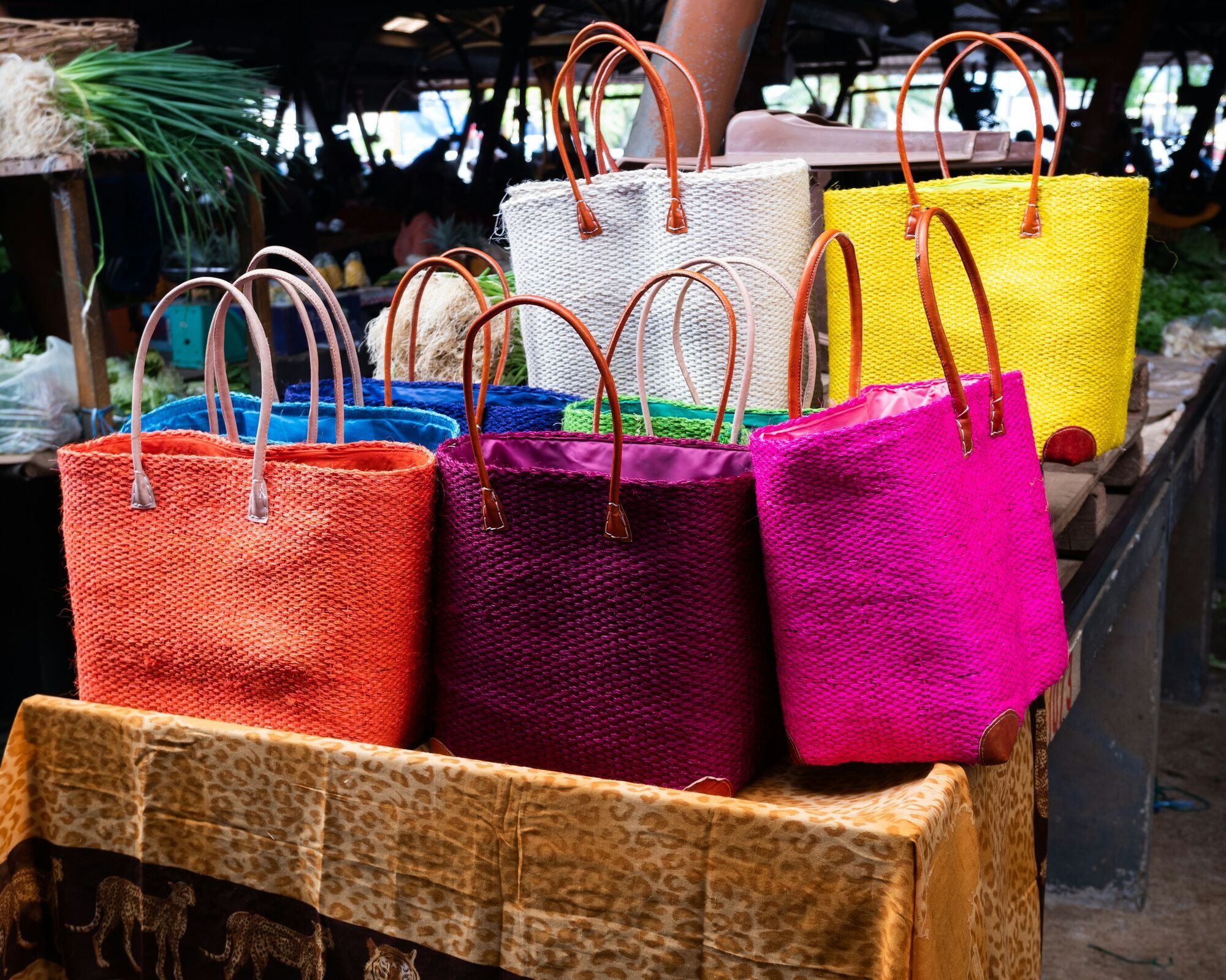 Colourful woven beach bags on display