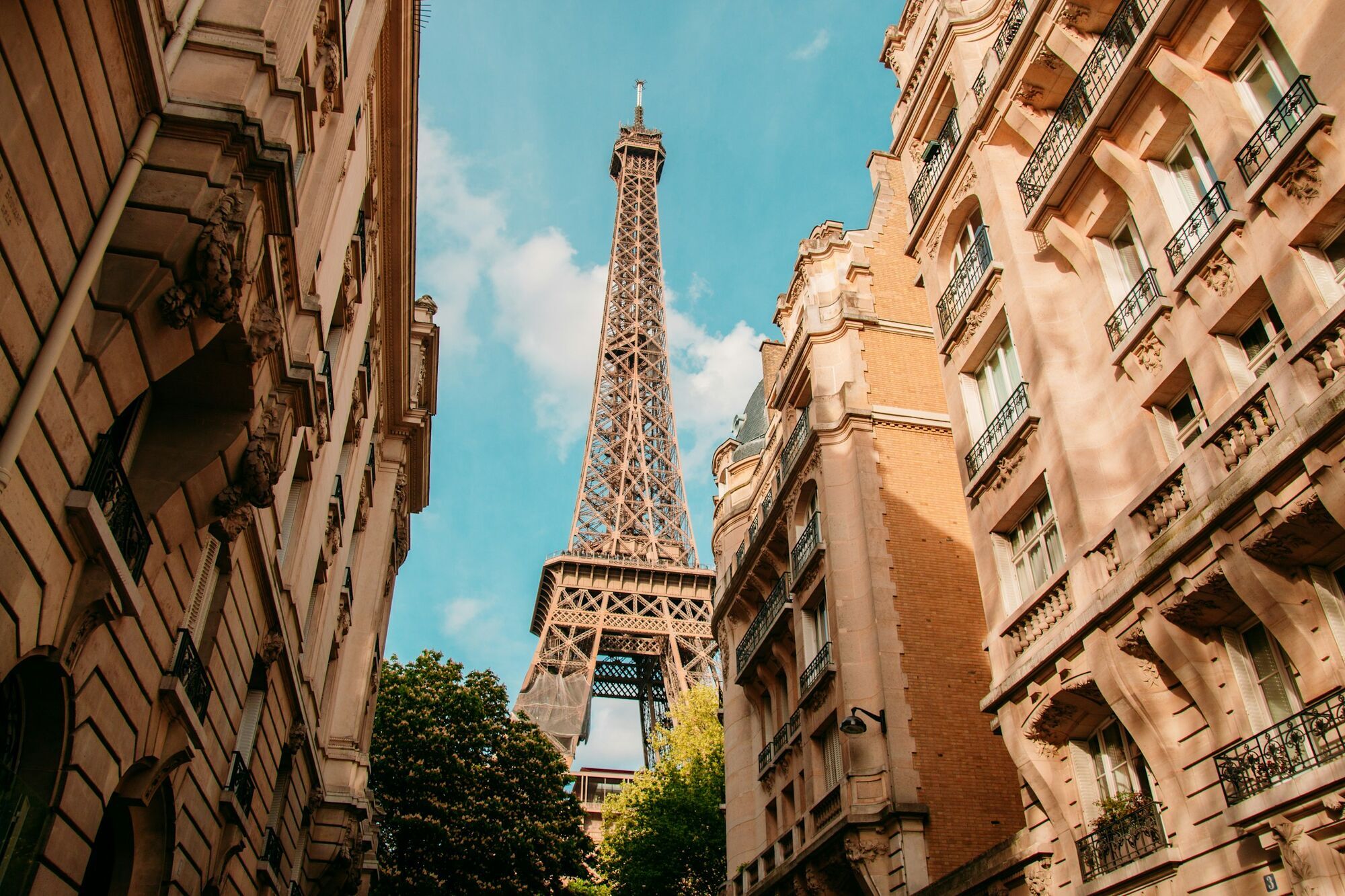 Eiffel Tower between Parisian buildings