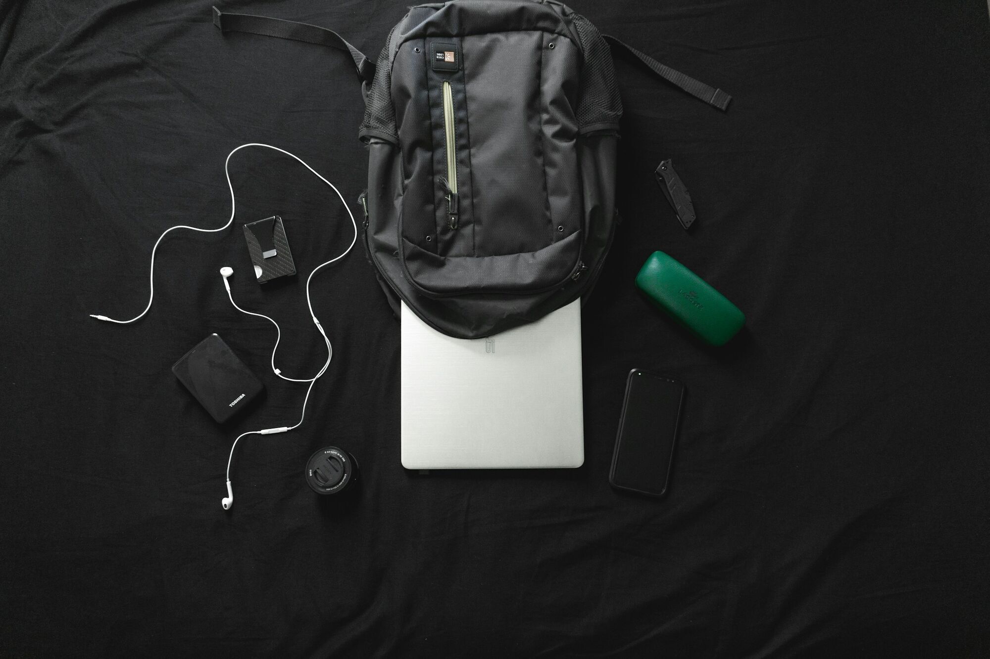 Laptop and electronic devices beside a cabin bag