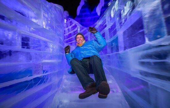 Visitor riding an ice slide at the ICE! Christmas attraction